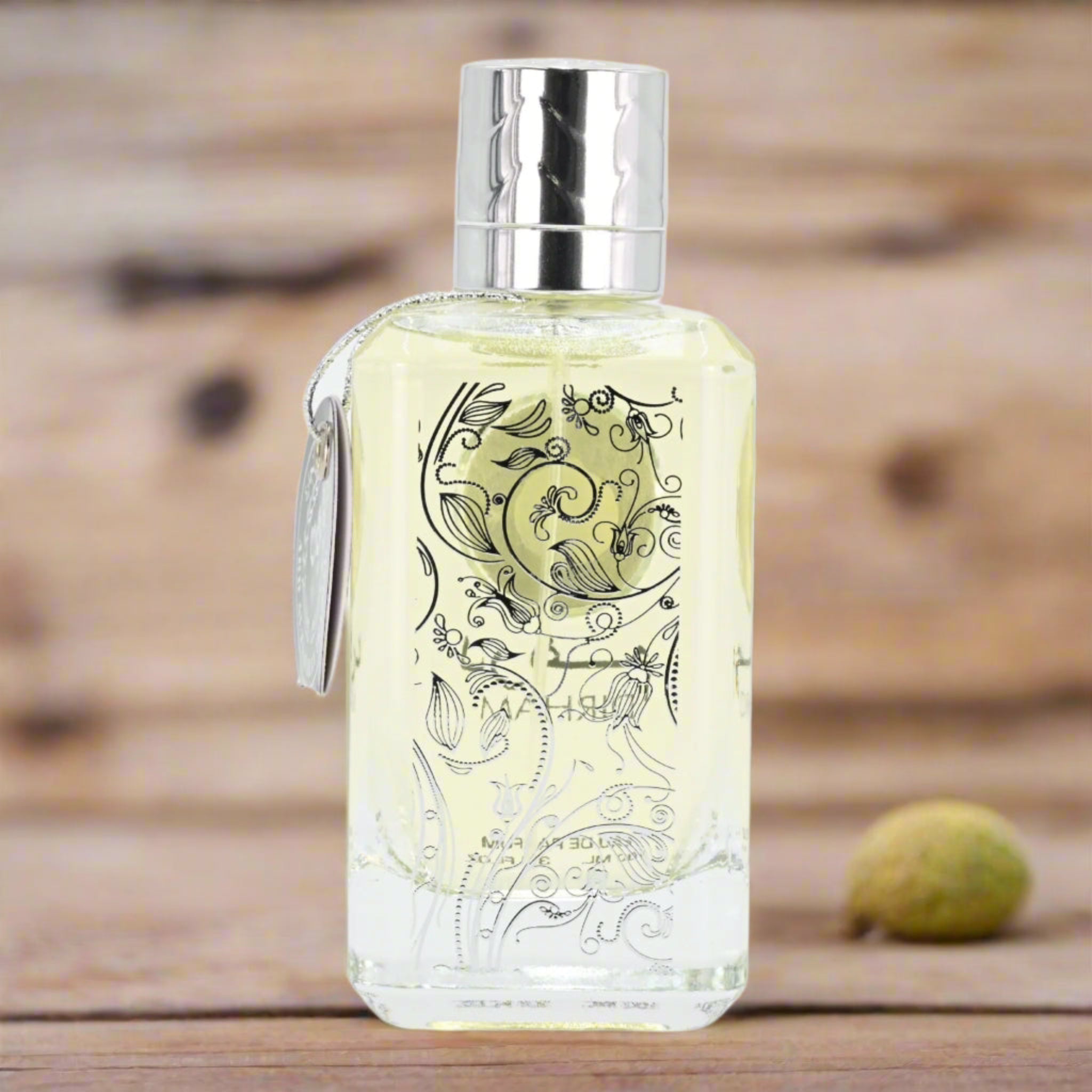 Decorative bottle with intricate designs on a wooden surface