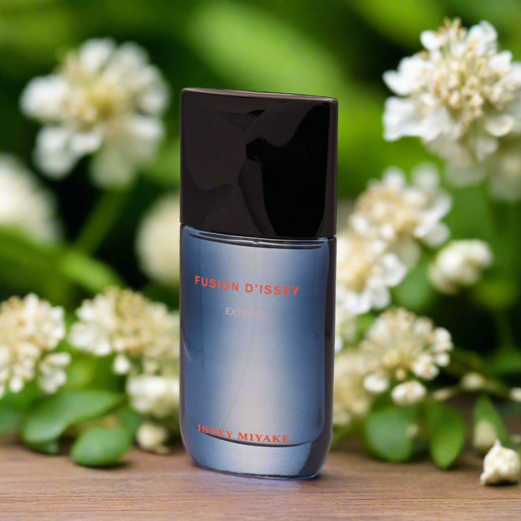 Blue perfume bottle with black cap labeled 'Fusion D'Issey' on a white background