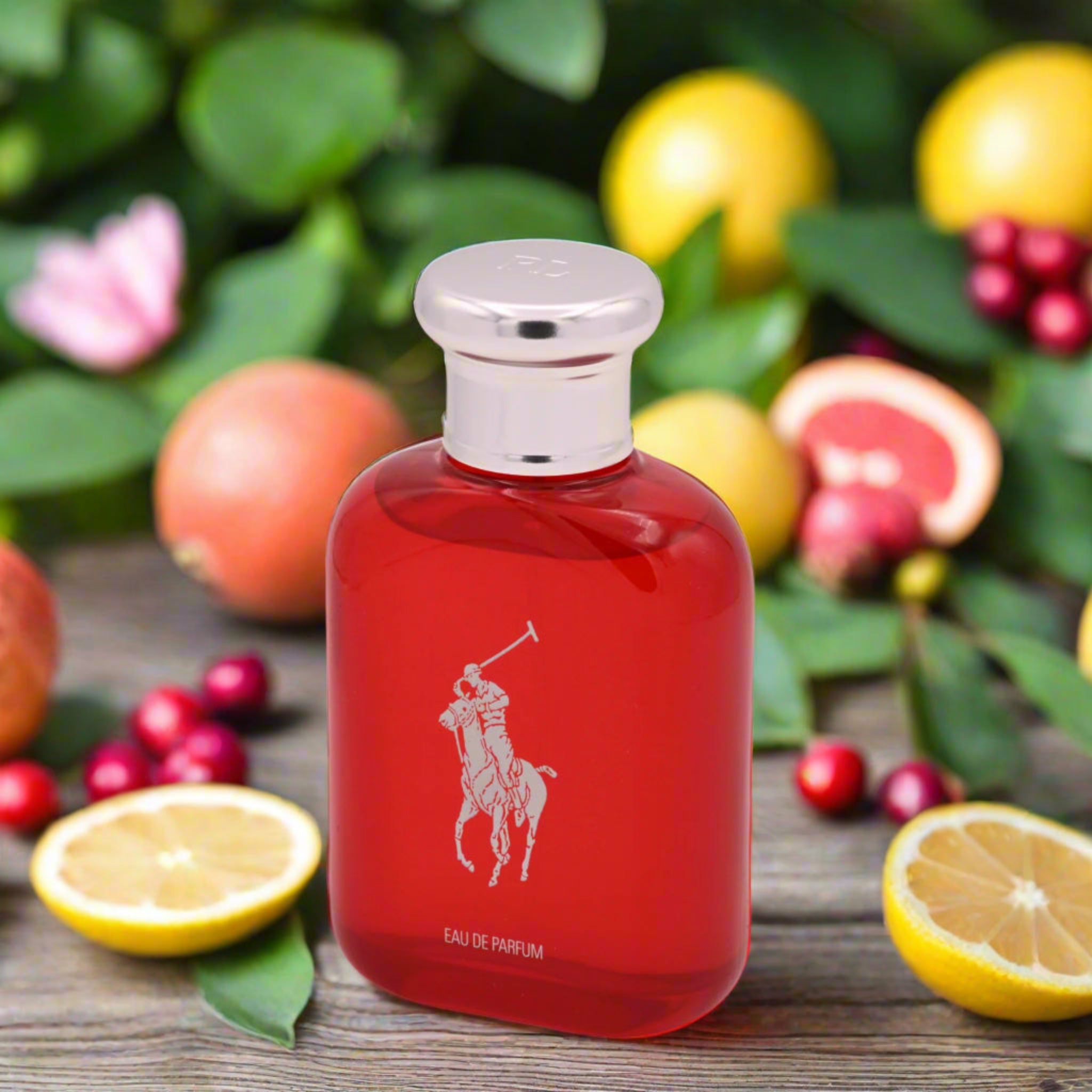 Red Ralph Lauren perfume bottle with fruit and leaves in the background