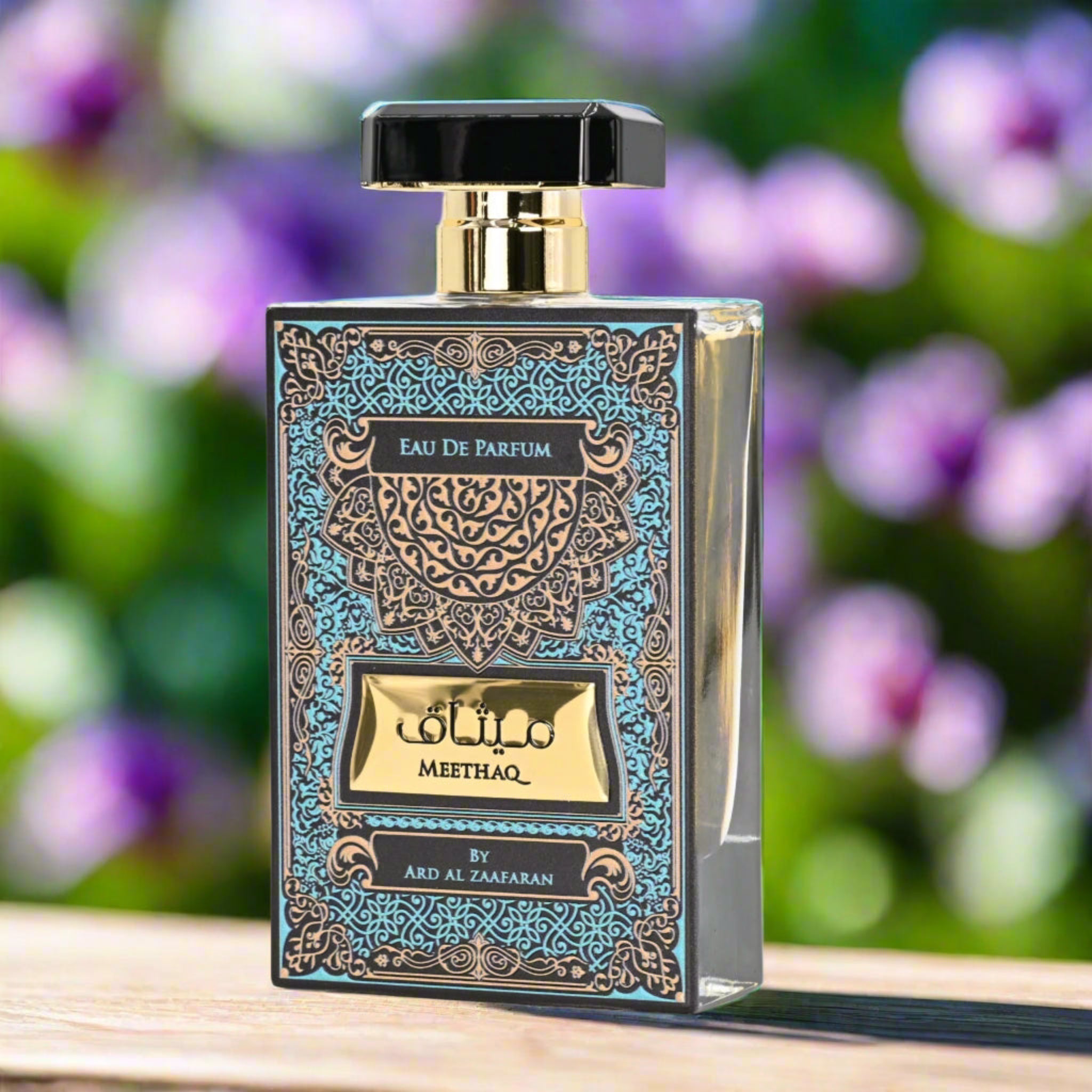 Perfume bottle with decorative label on a wooden surface with a blurred floral background
