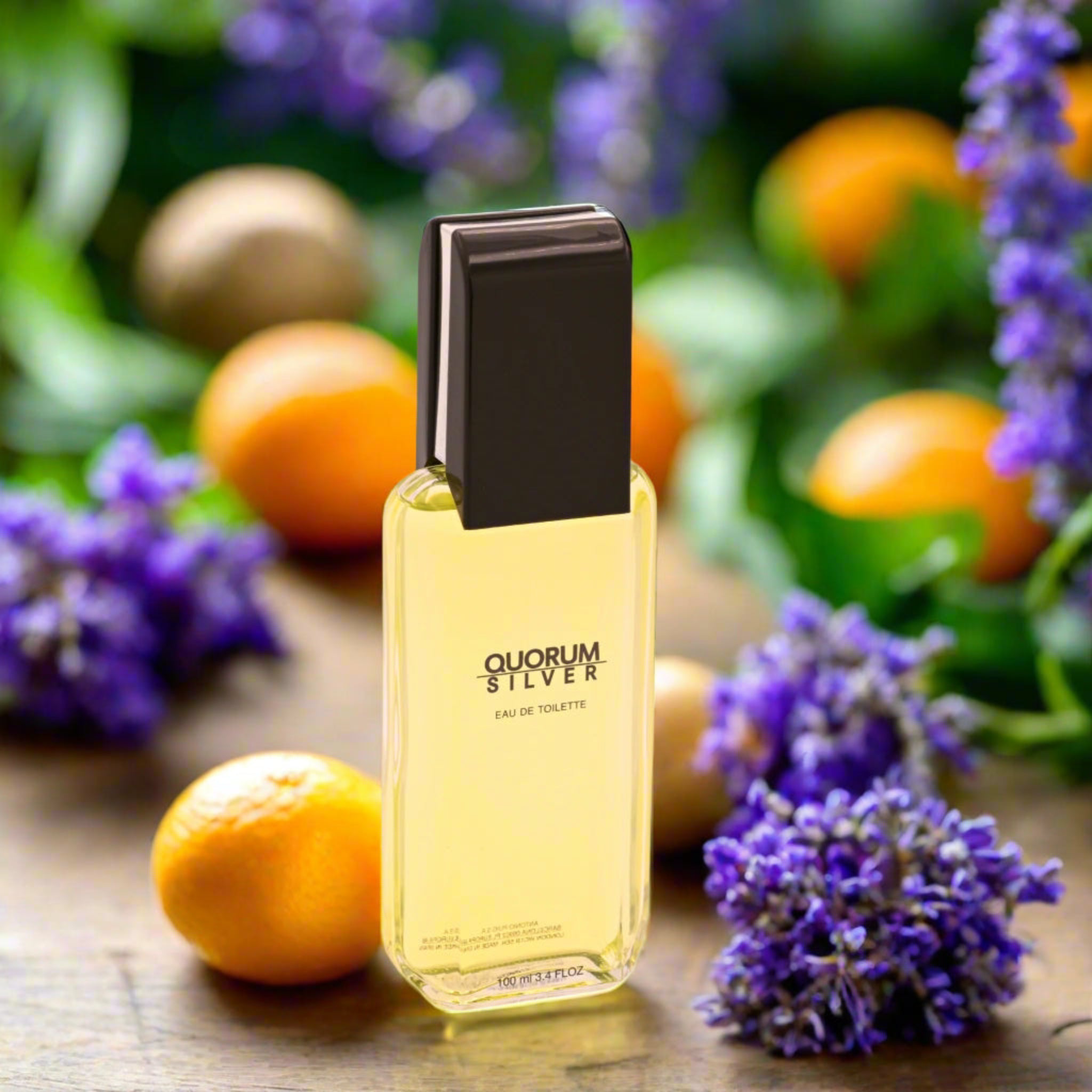Quorum Silver perfume bottle with oranges and lavender flowers in the background