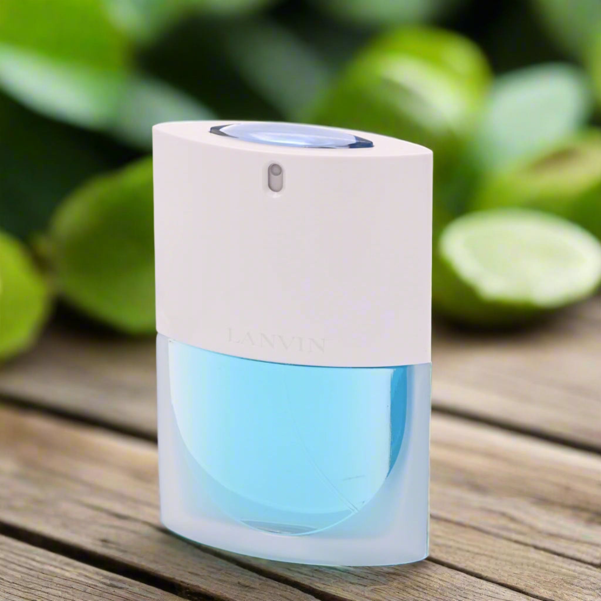 White and blue electronic device on a wooden surface with green kiwis in the background