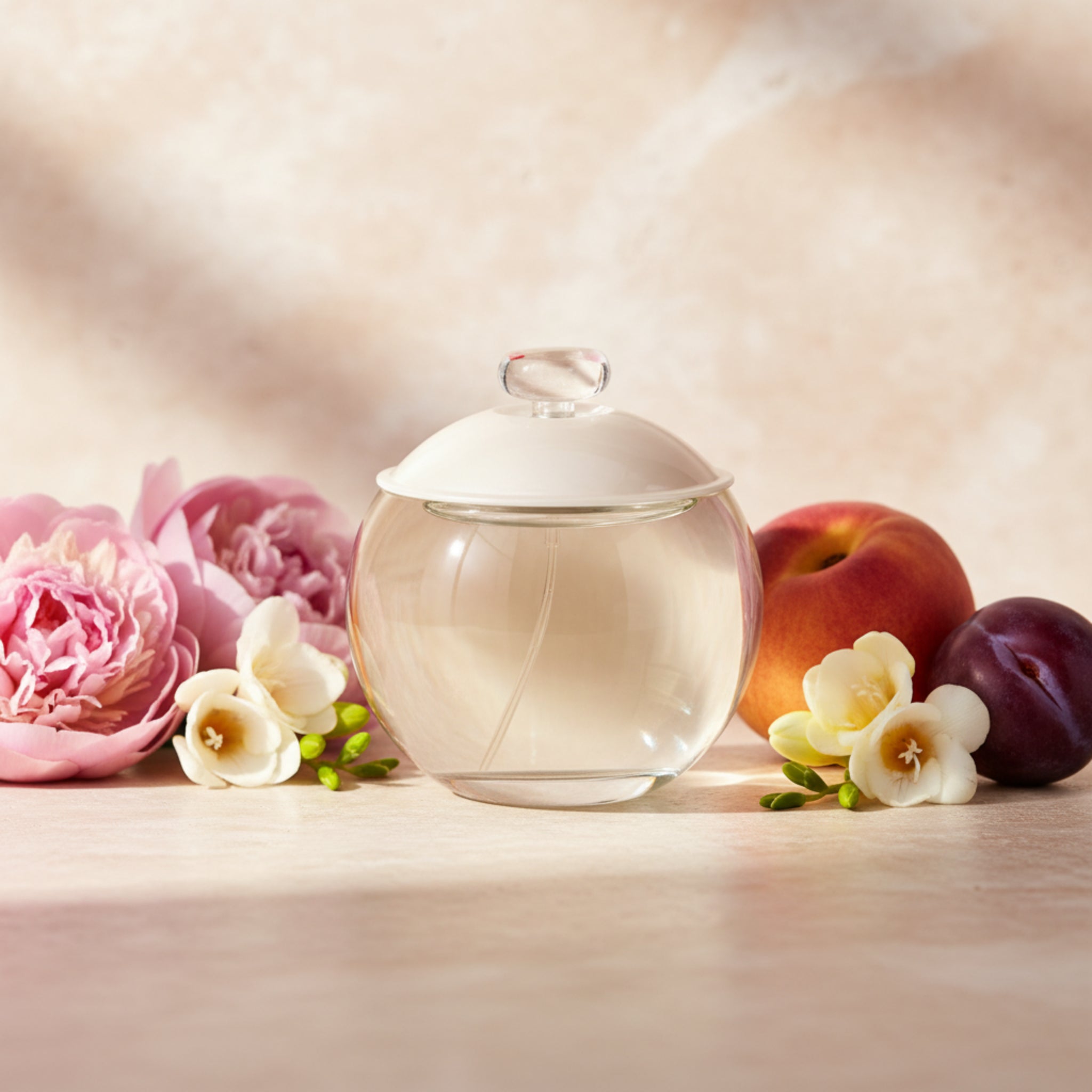 Clear glass perfume bottle with a white lid on a white background
