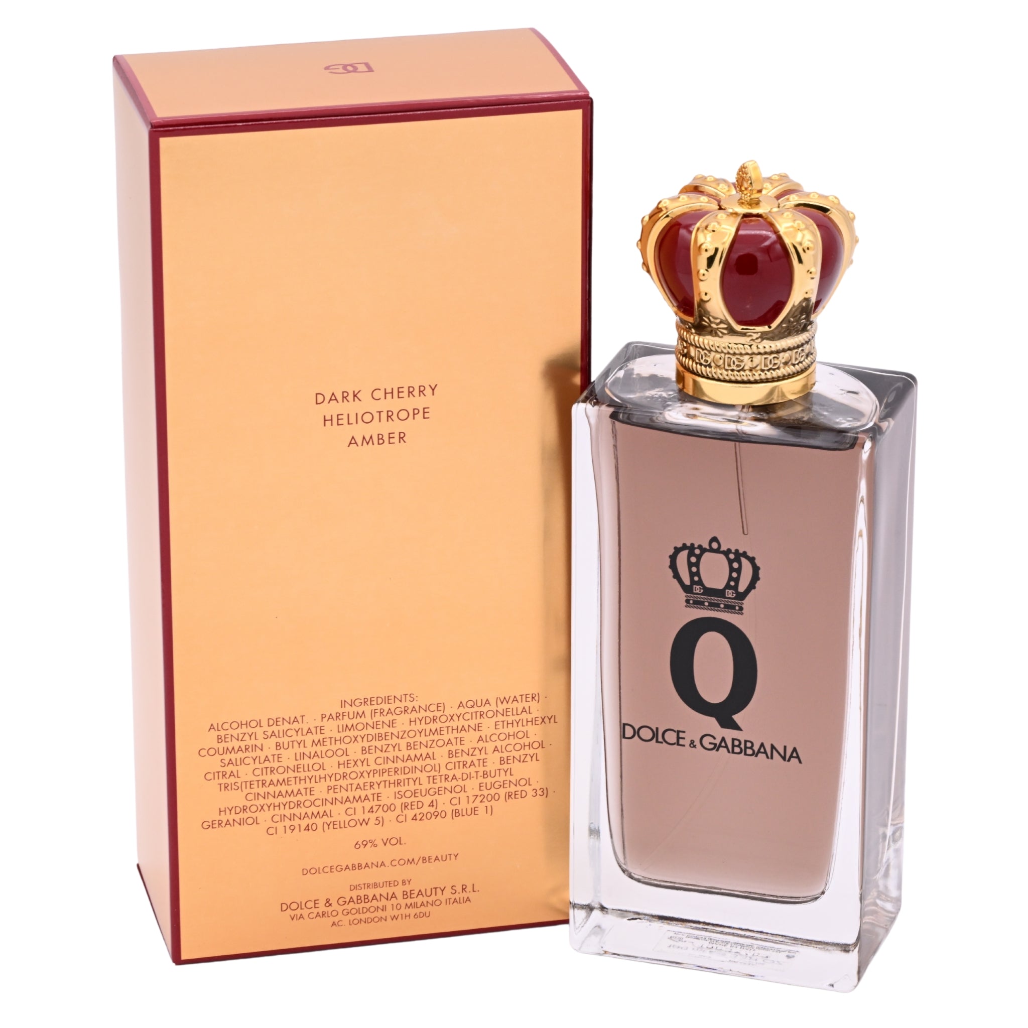 Dolce & Gabbana perfume bottle with gold crown and red gem on a white background