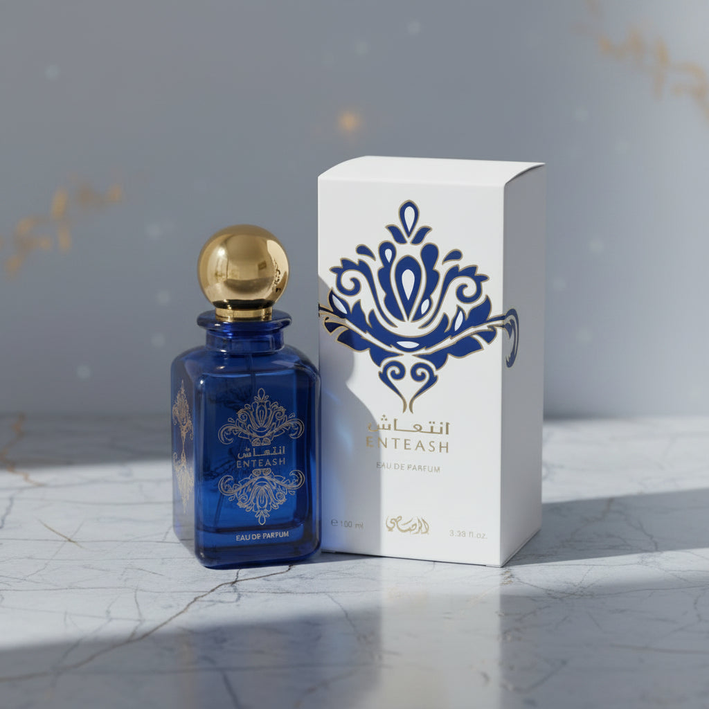 Blue perfume bottle with gold cap and decorative box on a white background