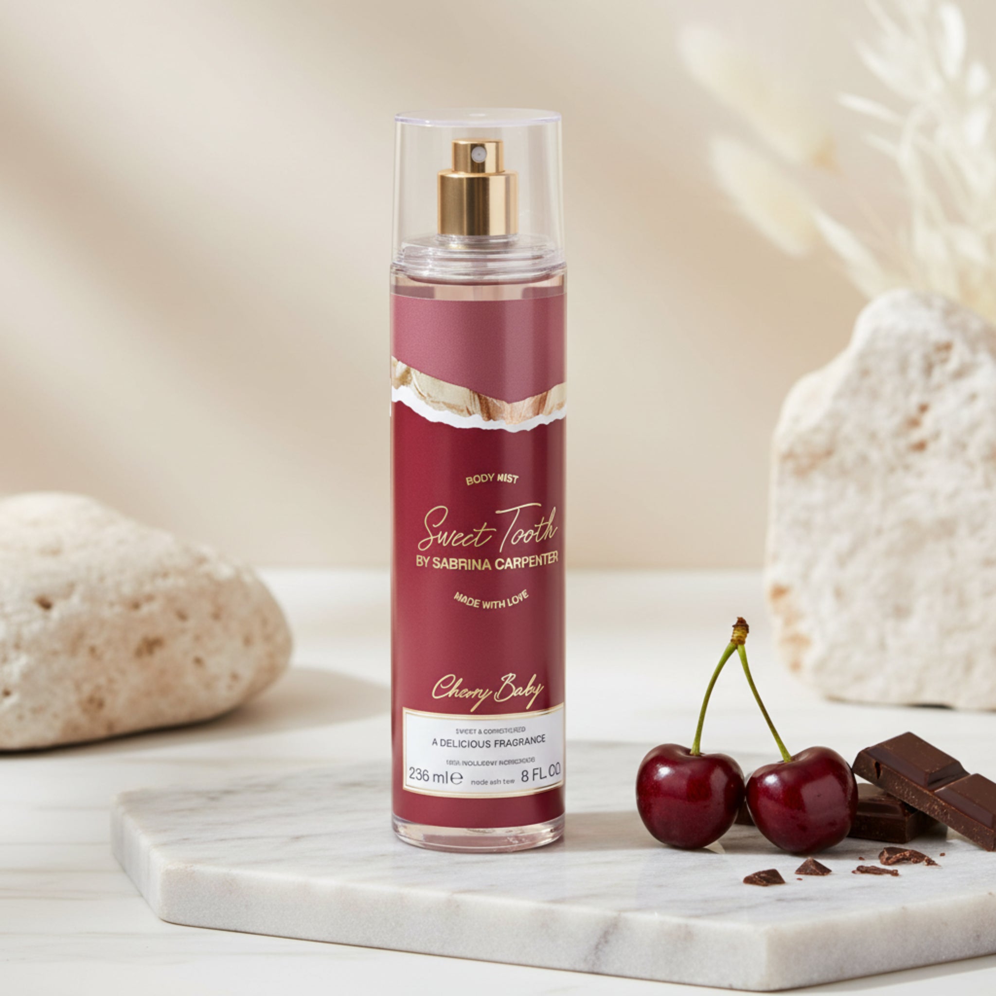 Body mist bottle labeled 'Sweet Tooth' by Sabrina Carpentieri on a white background