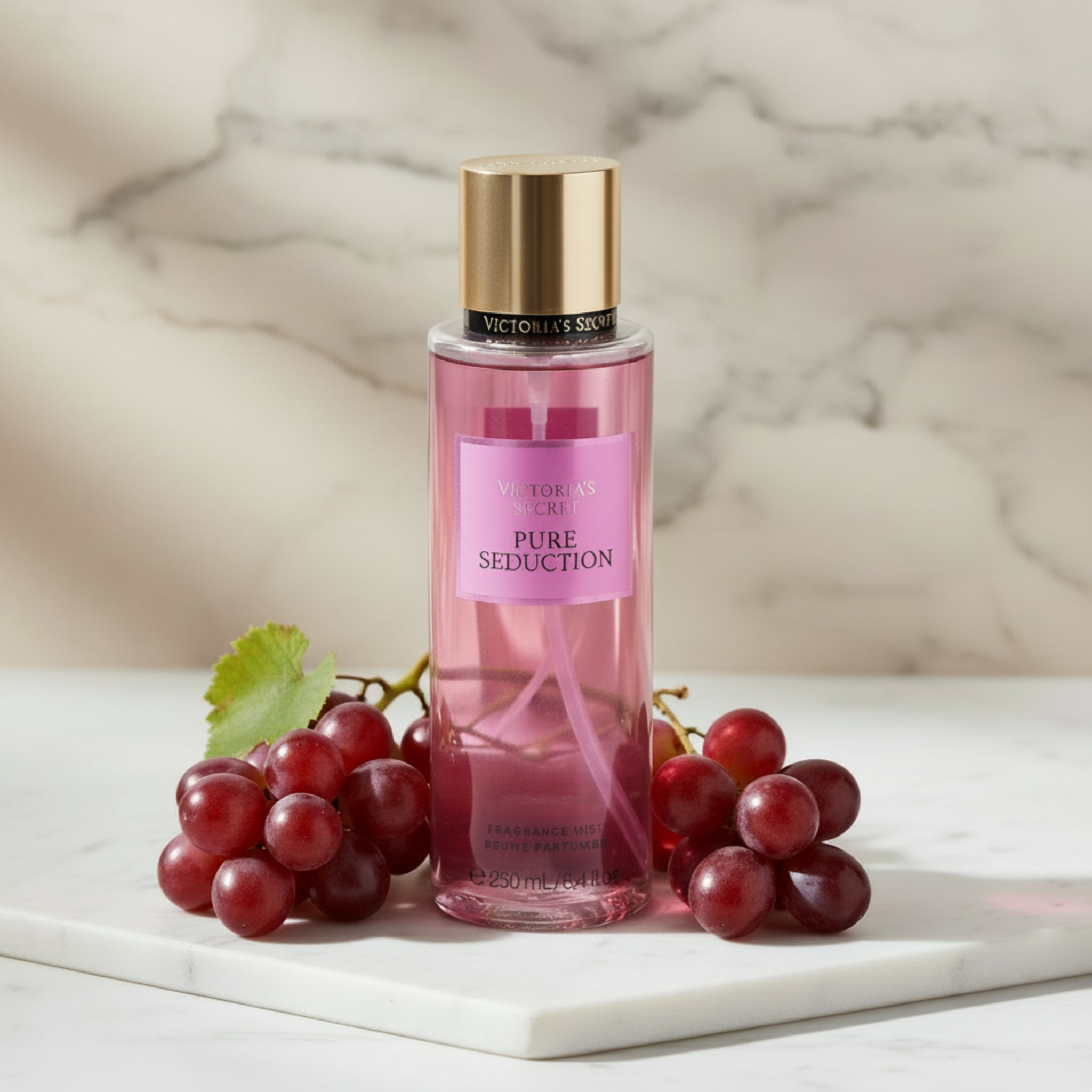 Pink Victoria's Secret Pure Seduction fragrance mist bottle on a white background