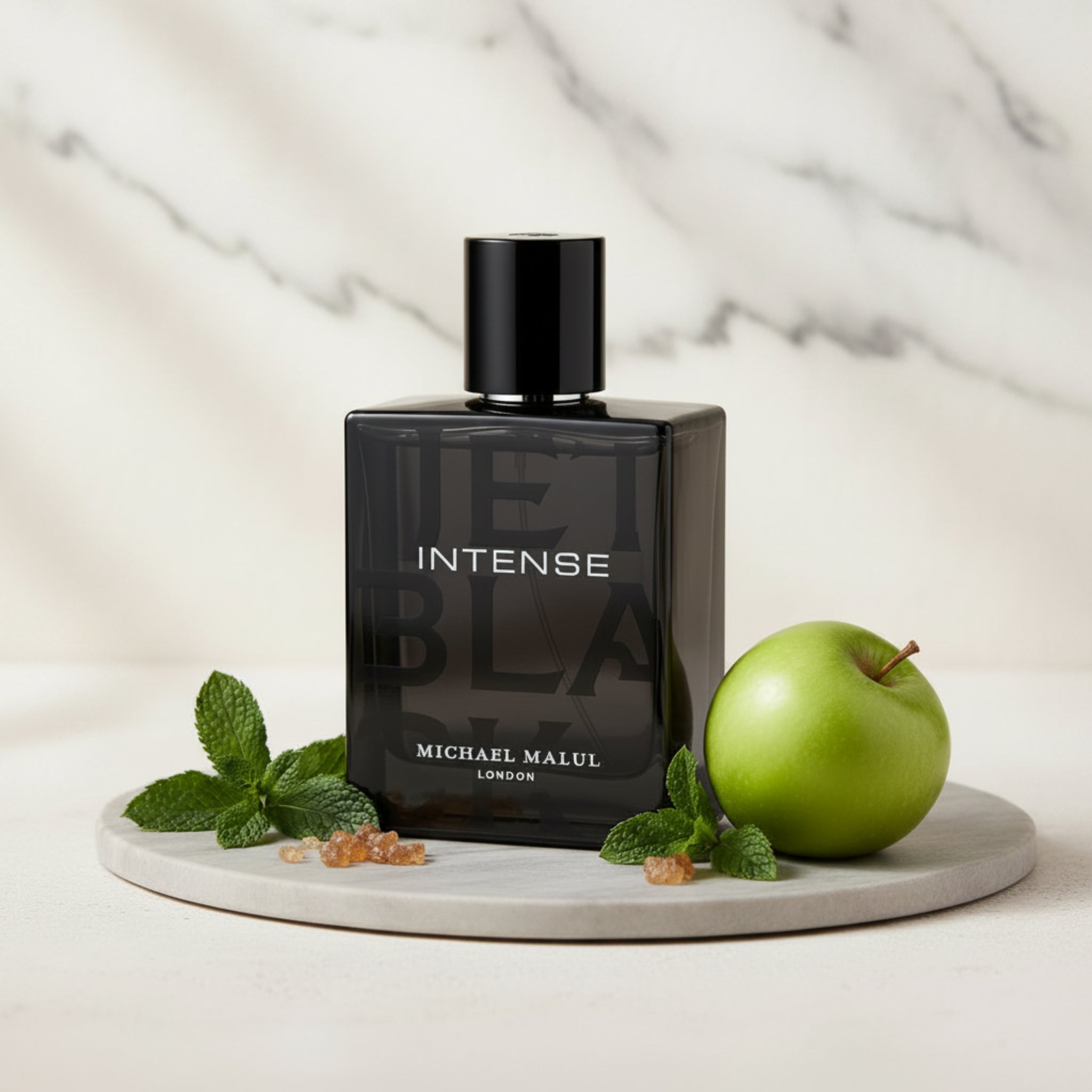 Black perfume bottle labeled 'Intense' by Michael Malul on a white background
