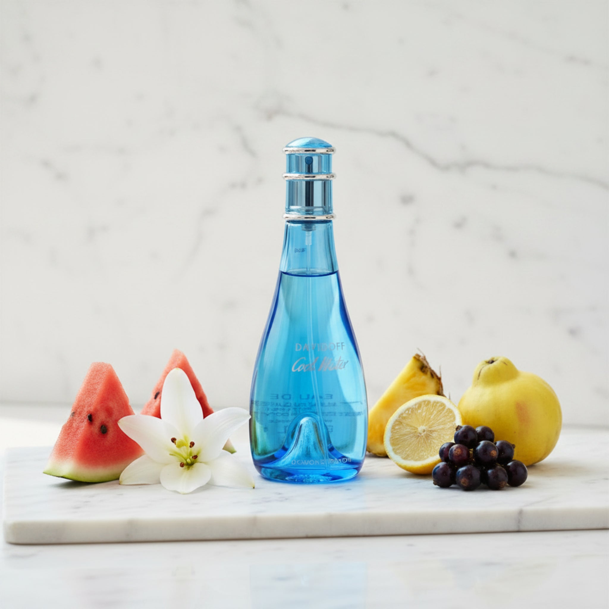 Blue perfume bottle with a silver cap on a white background