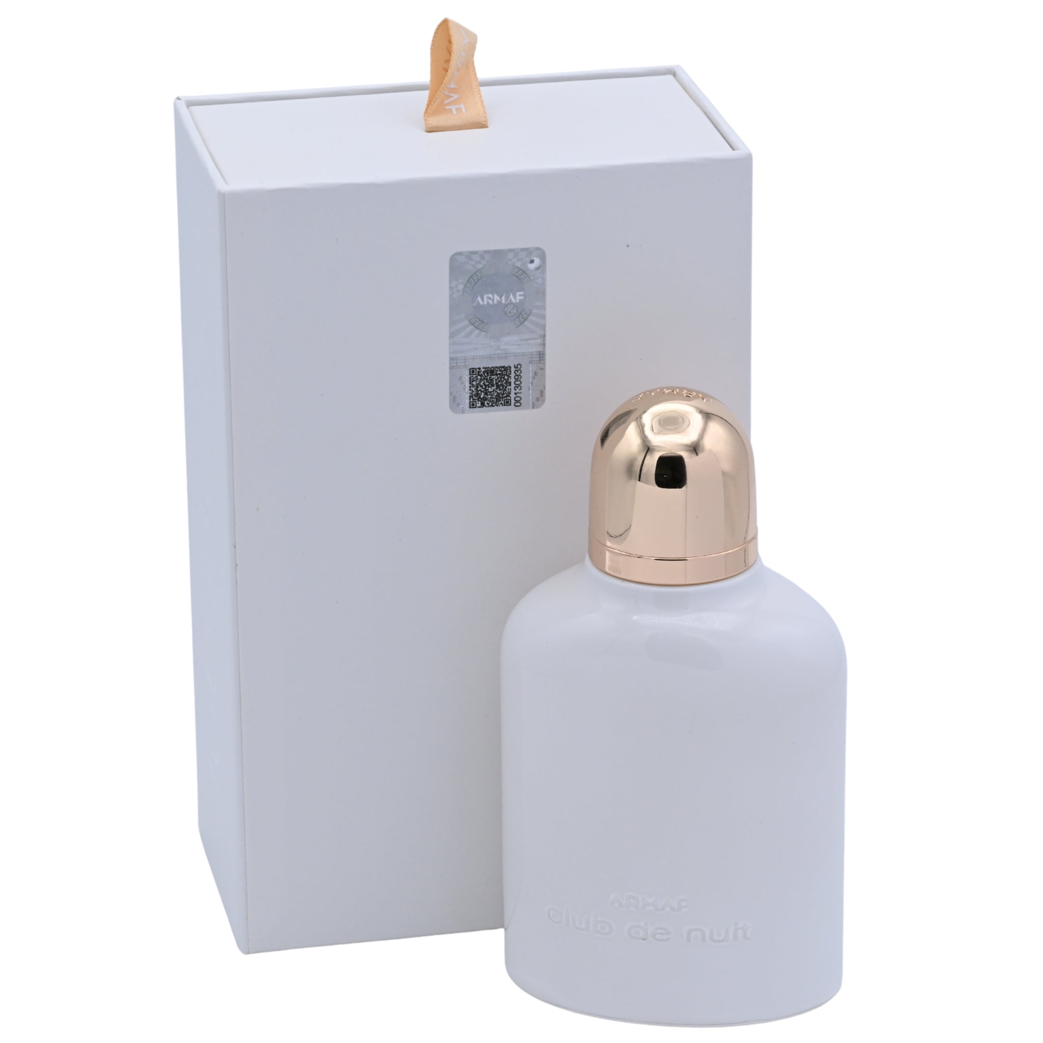 White spray bottle with gold cap in front of a white box on a white background