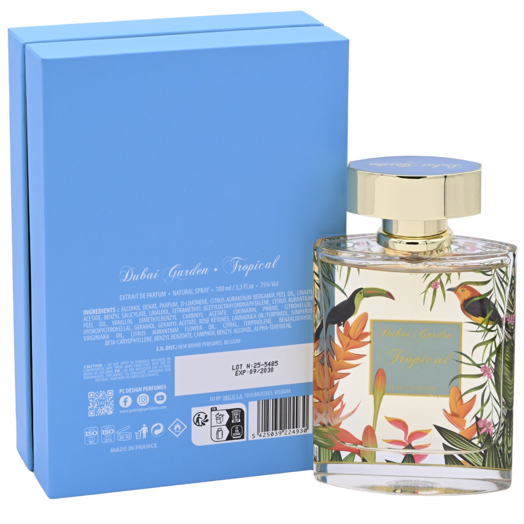 Perfume bottle with tropical design and matching blue packaging on a white background
