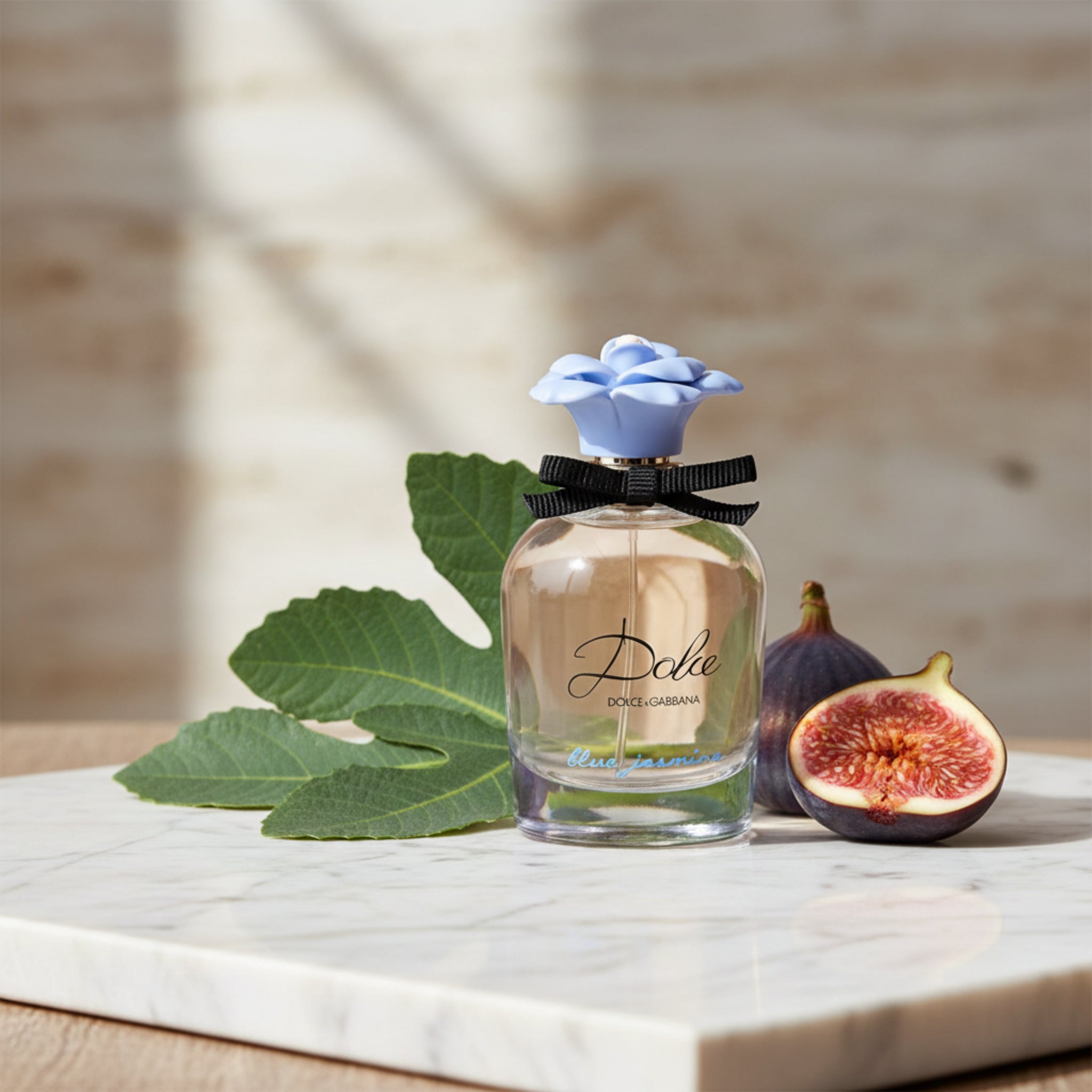 Dolce & Gabbana Blue Jasmine perfume bottle with a blue flower on a white background