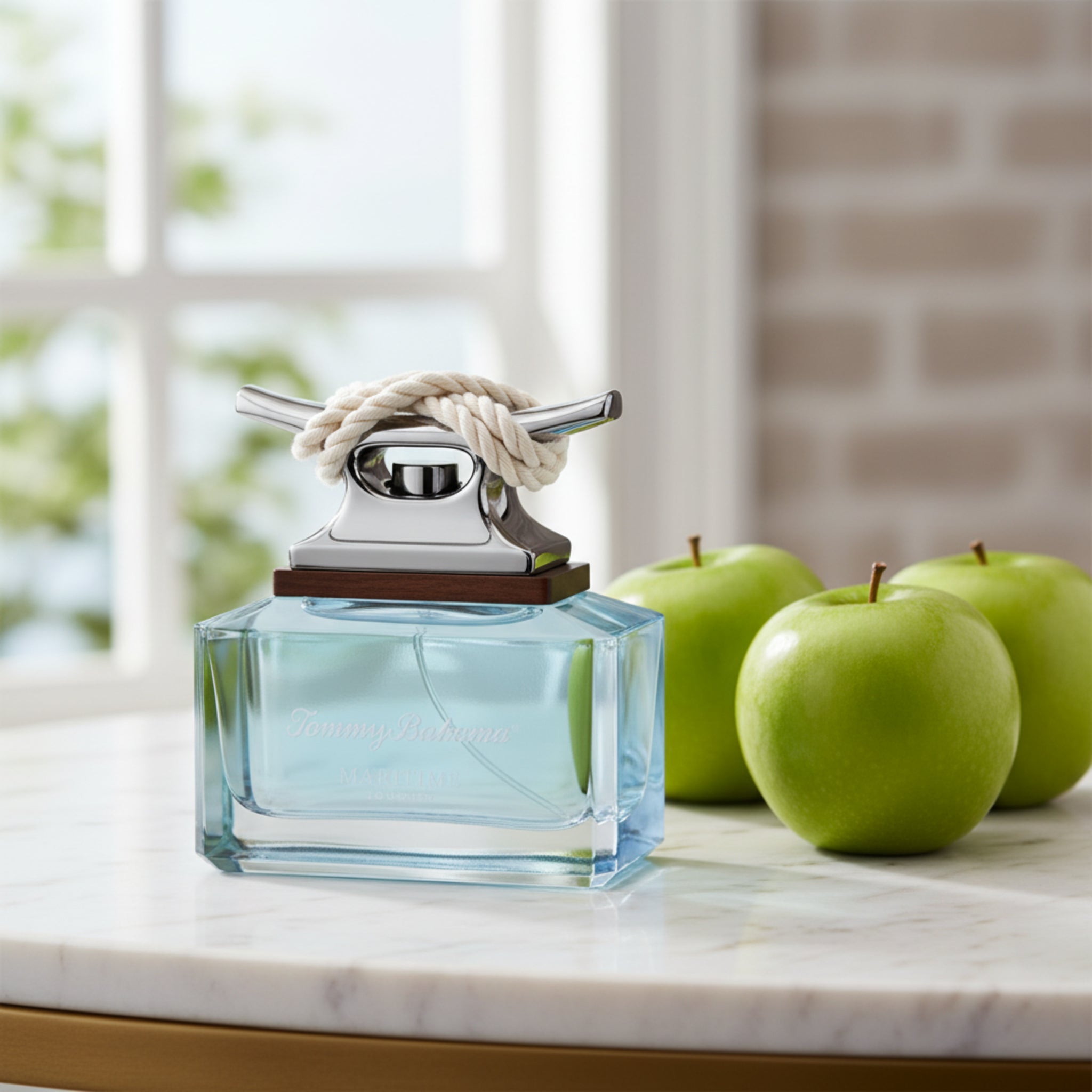 Blue glass perfume bottle with a silver and white cap on a white background