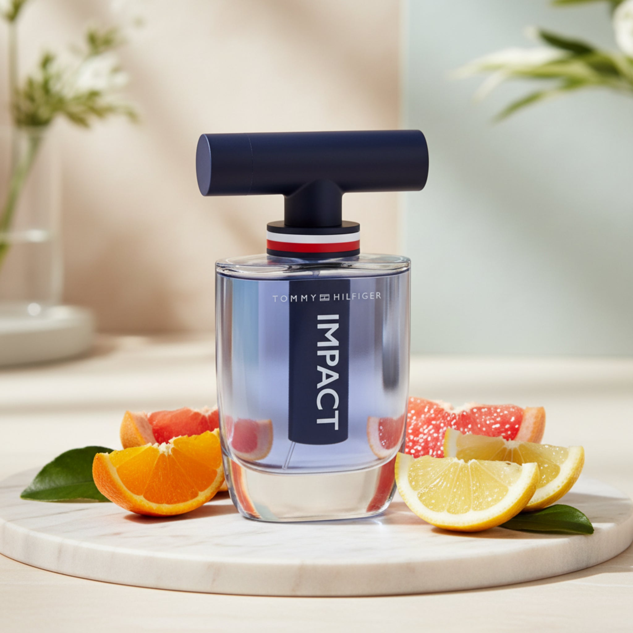 Tommy Hilfiger Impact perfume bottle on a table with fruits