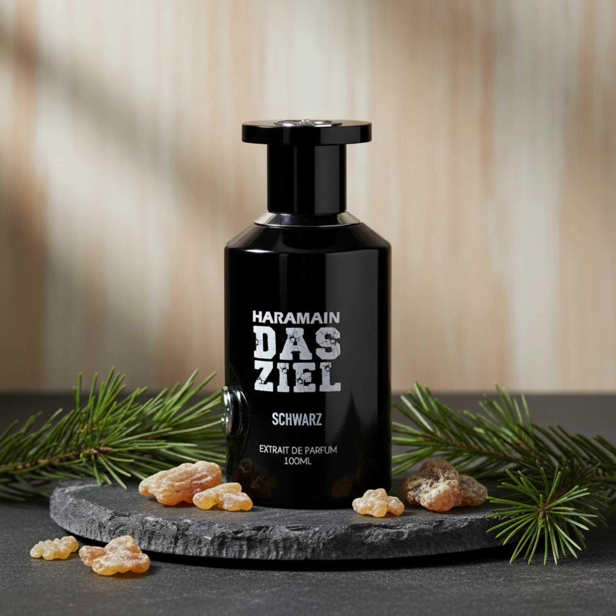 Black perfume bottle with 'Haramain Das Ziel Schwarz' text on a white background