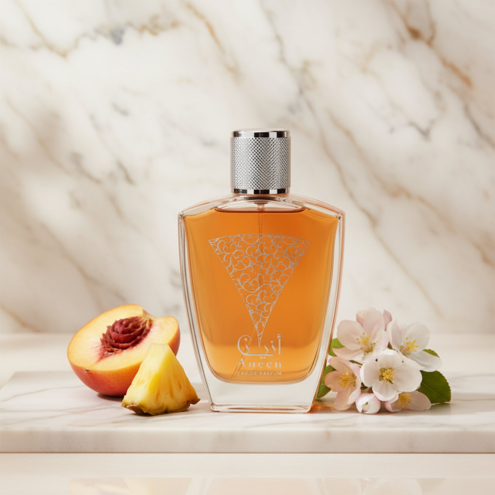 Orange perfume bottle with silver cap on a white background