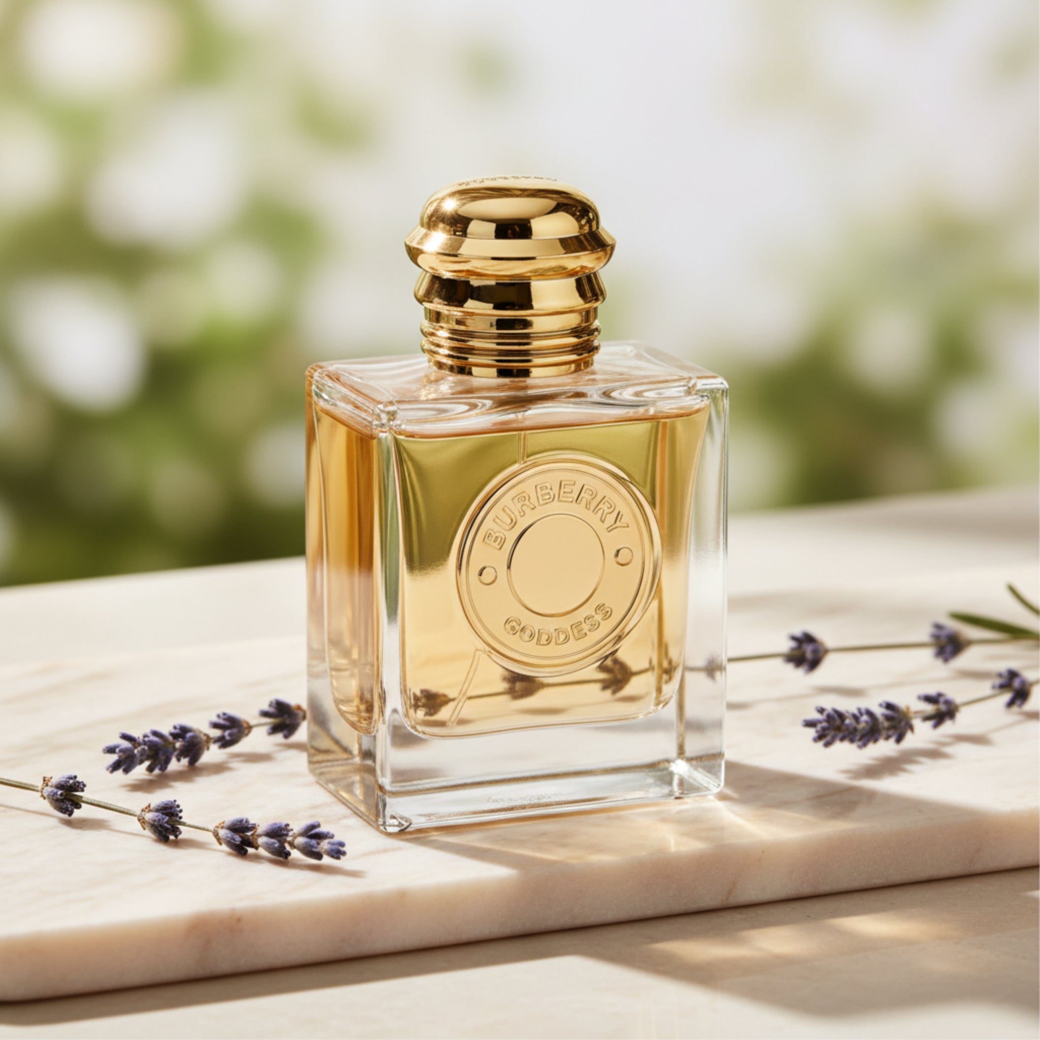 Perfume bottle with gold cap and clear body on a white background