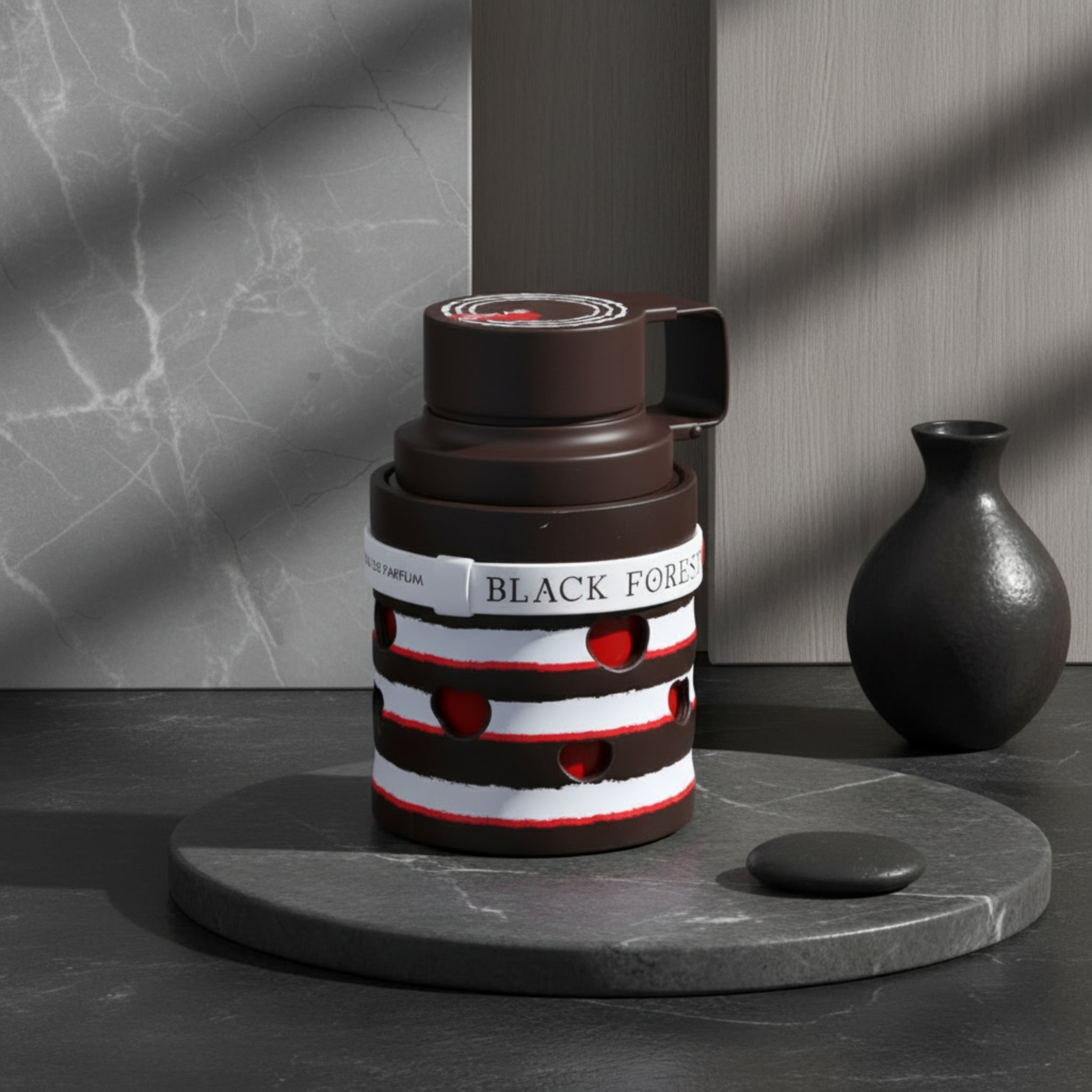 Perfume bottle with black, white, and red design on a white background