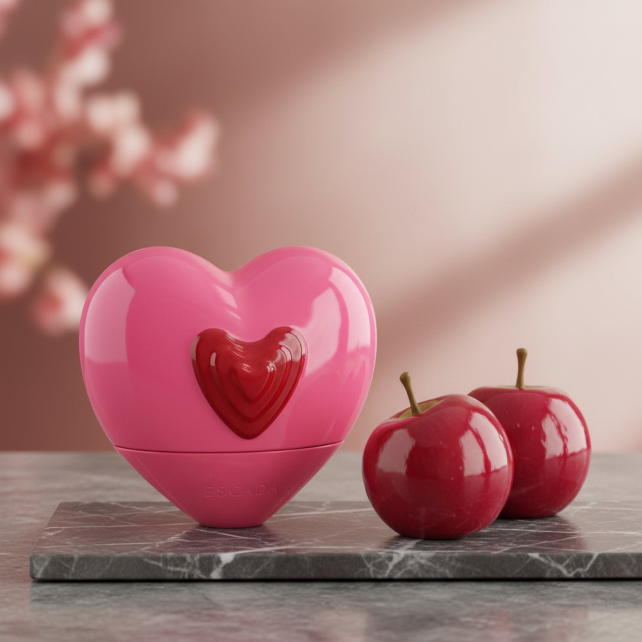 Pink heart-shaped Escada candy love perfume bottle on a white background