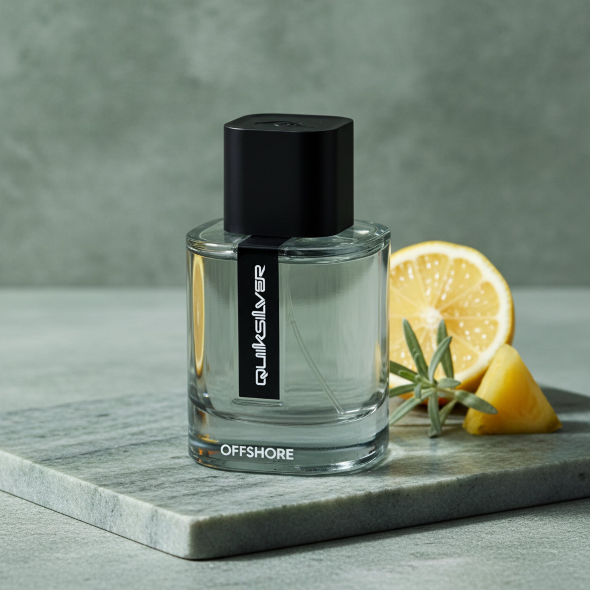 Clear perfume bottle with black cap on a white background