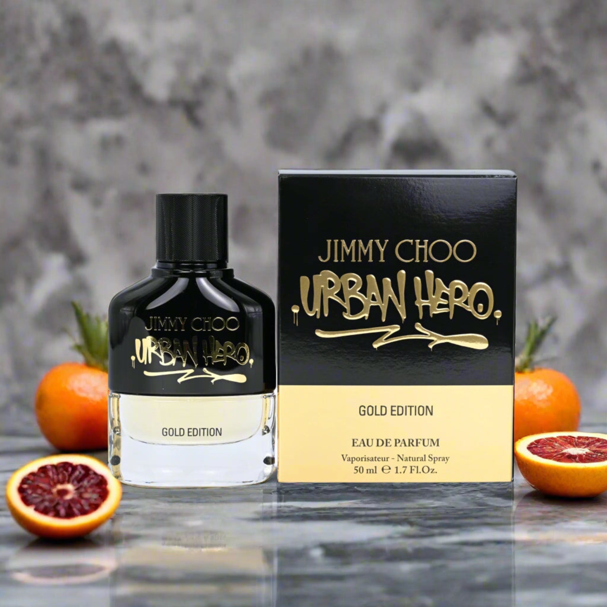 Urban Hero Gold Edition by Jimmy Choo perfume bottle and box on a blurred background