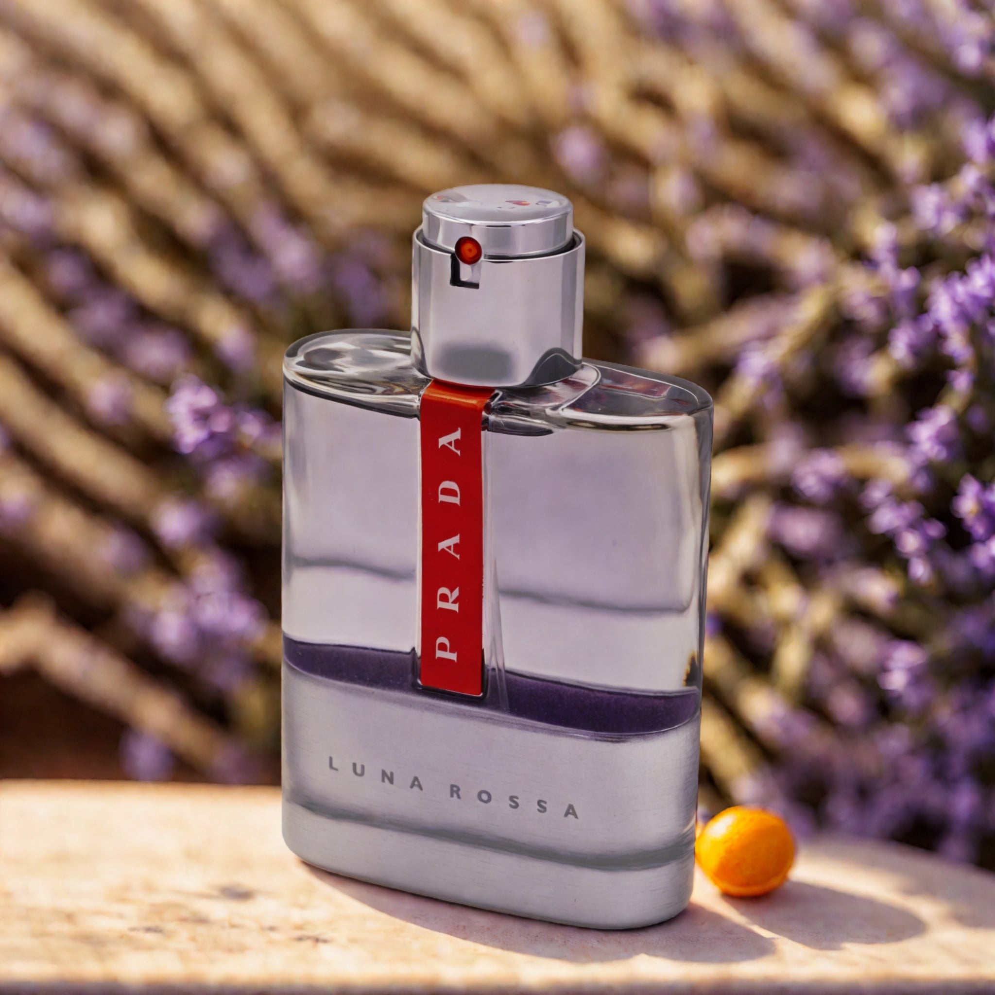 Prada Luna Rossa perfume bottle with a blurred natural background