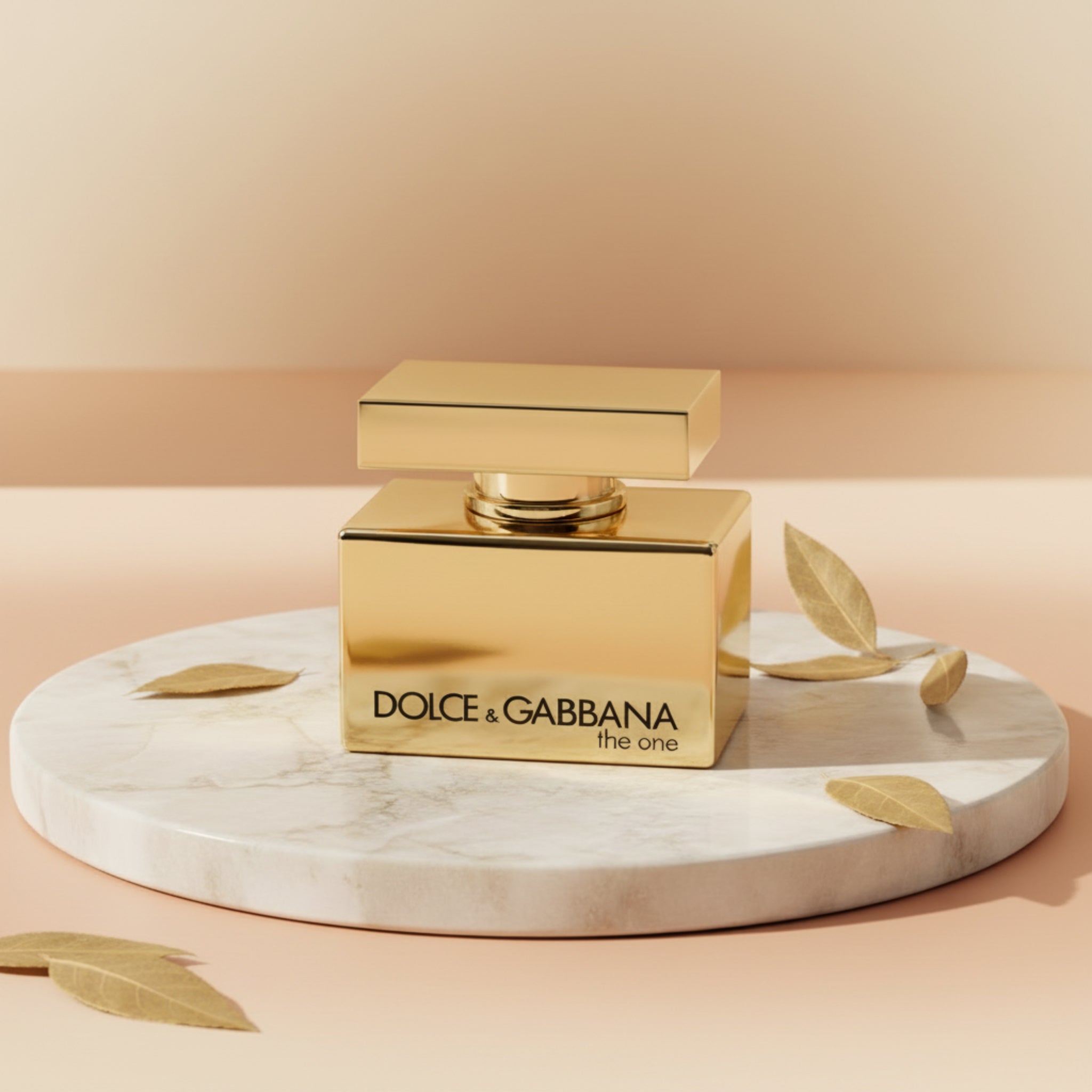 Gold Dolce & Gabbana perfume bottle on a white background
