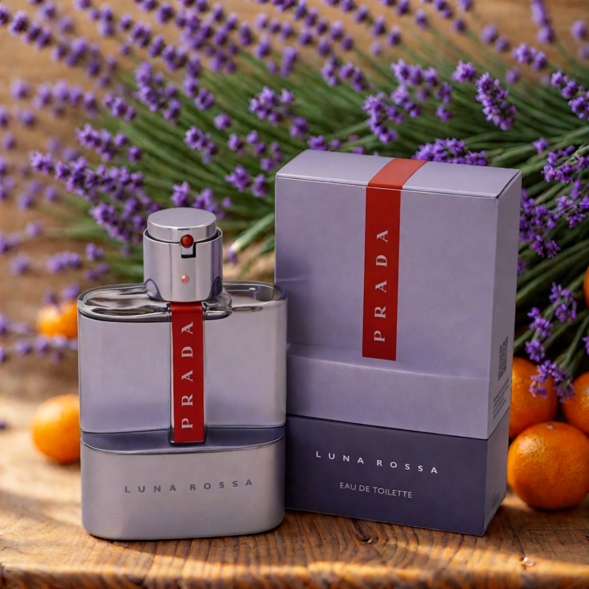 Prada Luna Rossa perfume bottle and packaging with lavender and oranges in the background