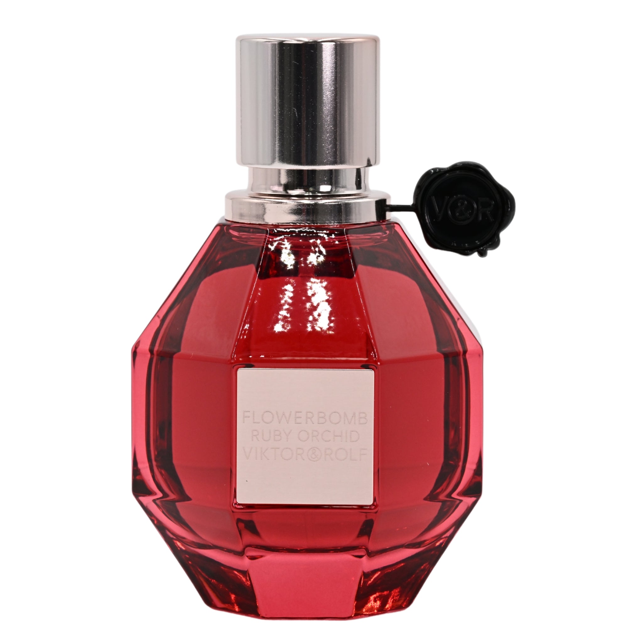 Red perfume bottle with silver cap on a white background
