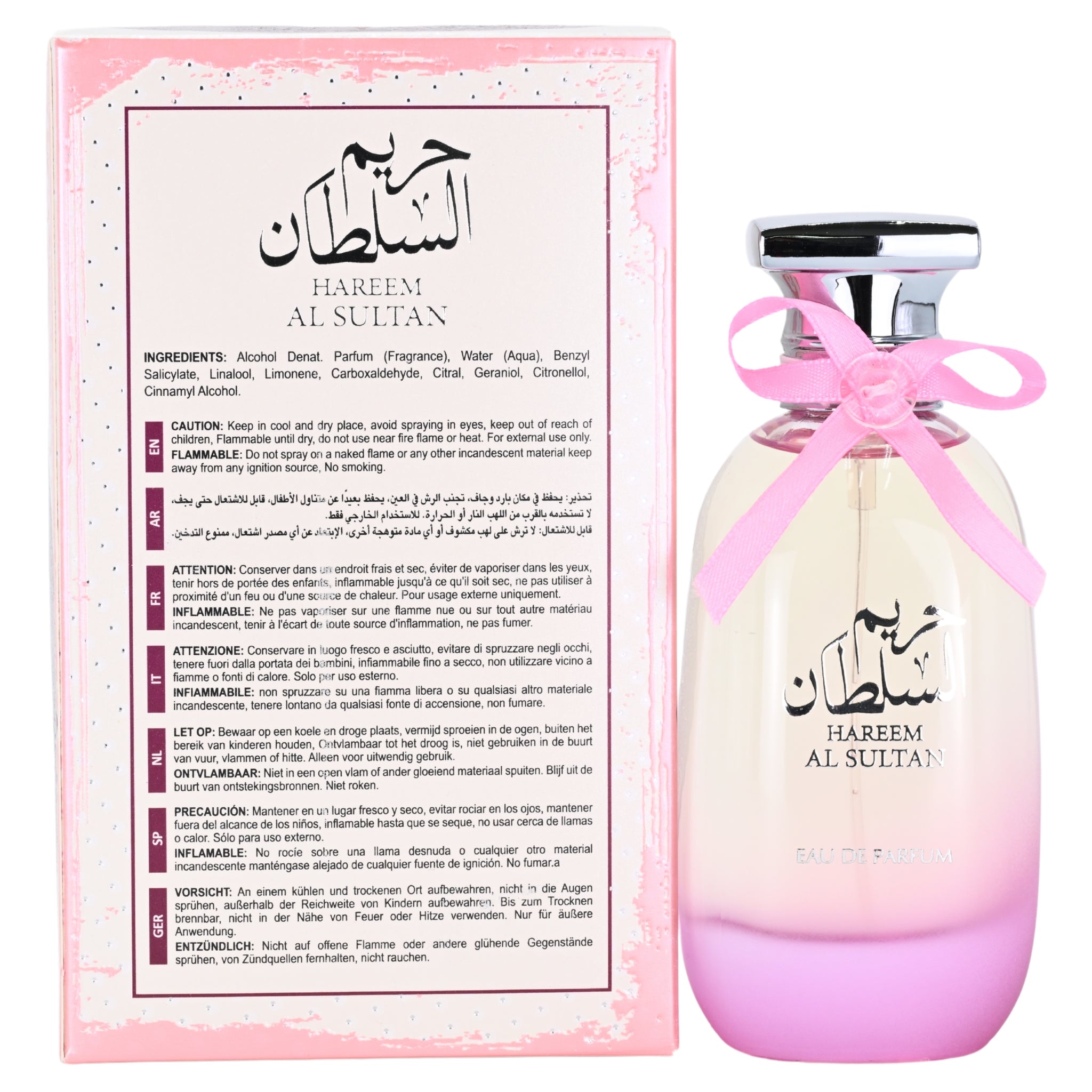 Perfume bottle with pink cap and ribbon next to its packaging on a white background