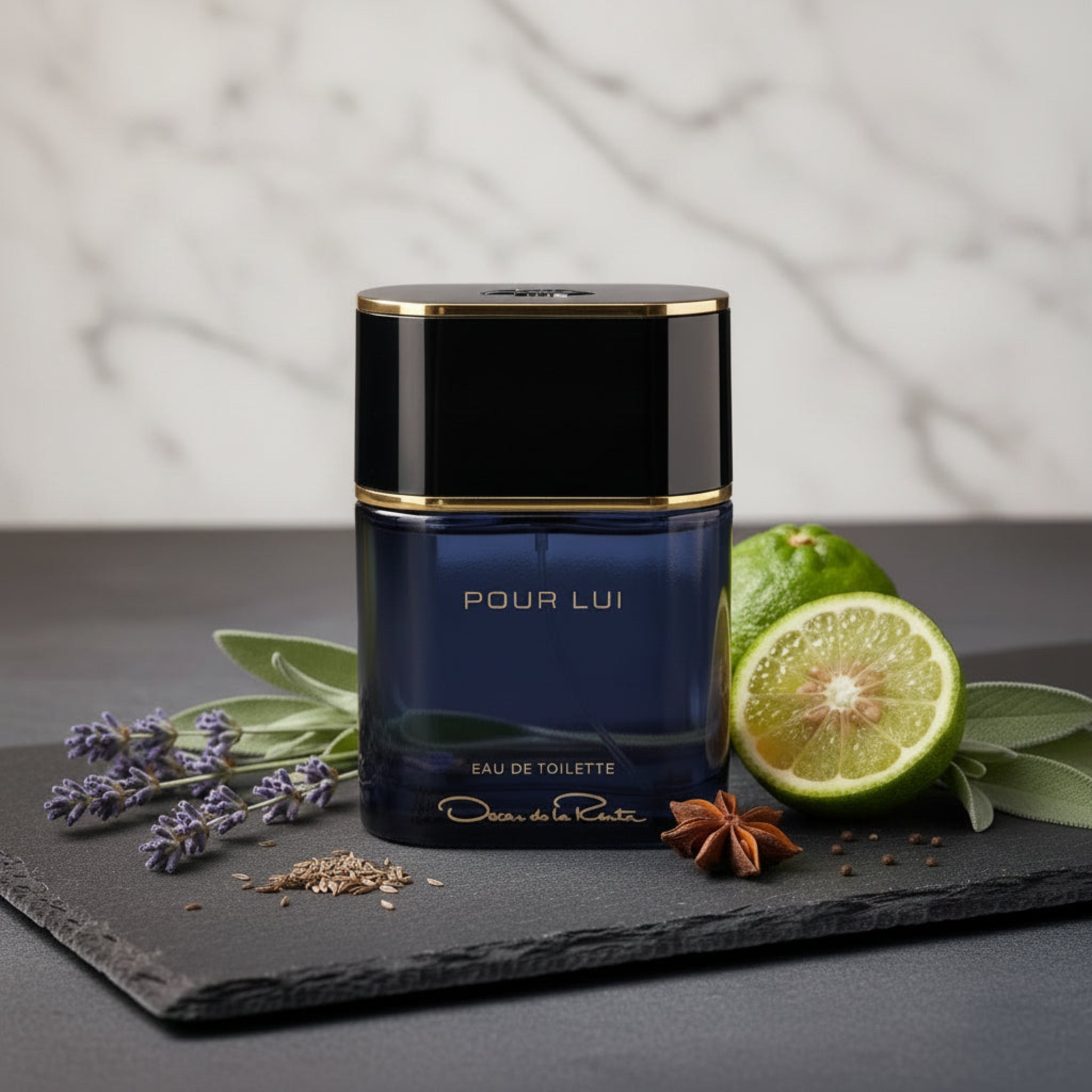 Perfume bottle labeled 'Pour Lui' with a lime, lavender, and star anise on a dark surface.