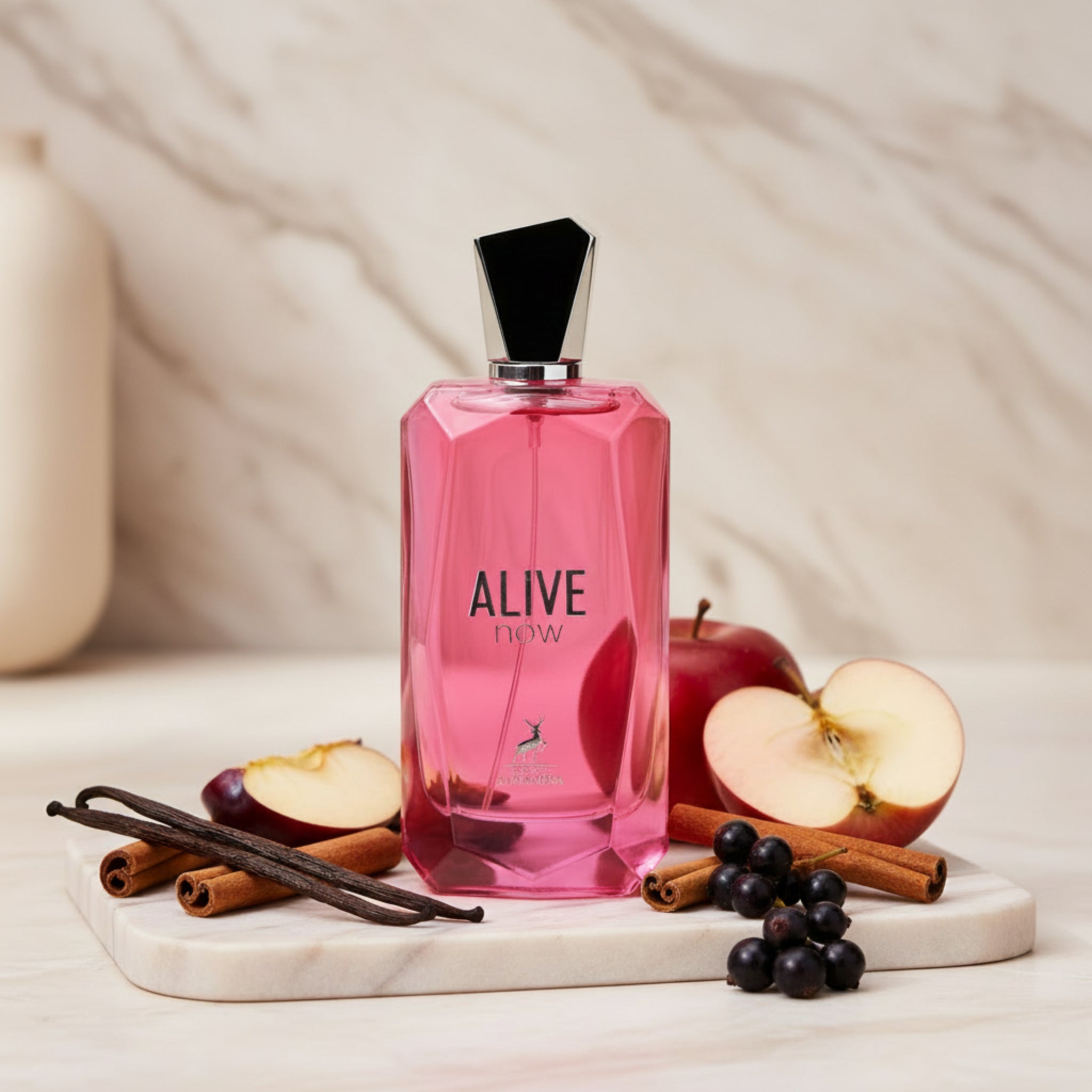 Pink perfume bottle labeled 'Alive' on a white background