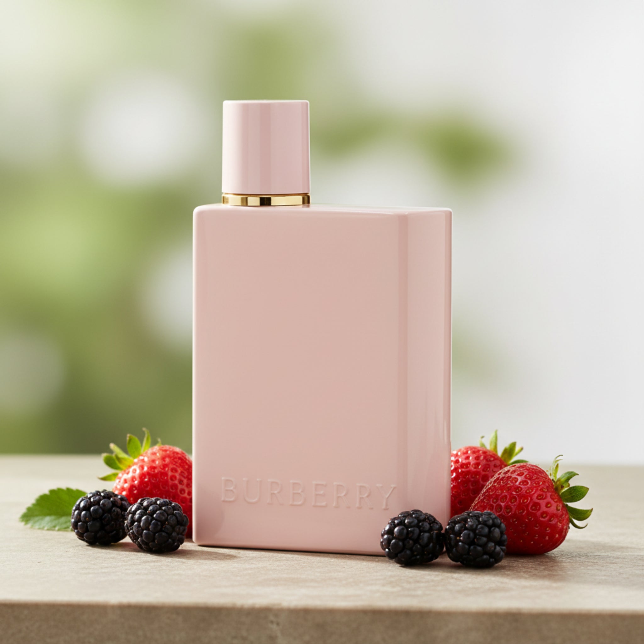 Pink perfume bottle with gold cap on a white background