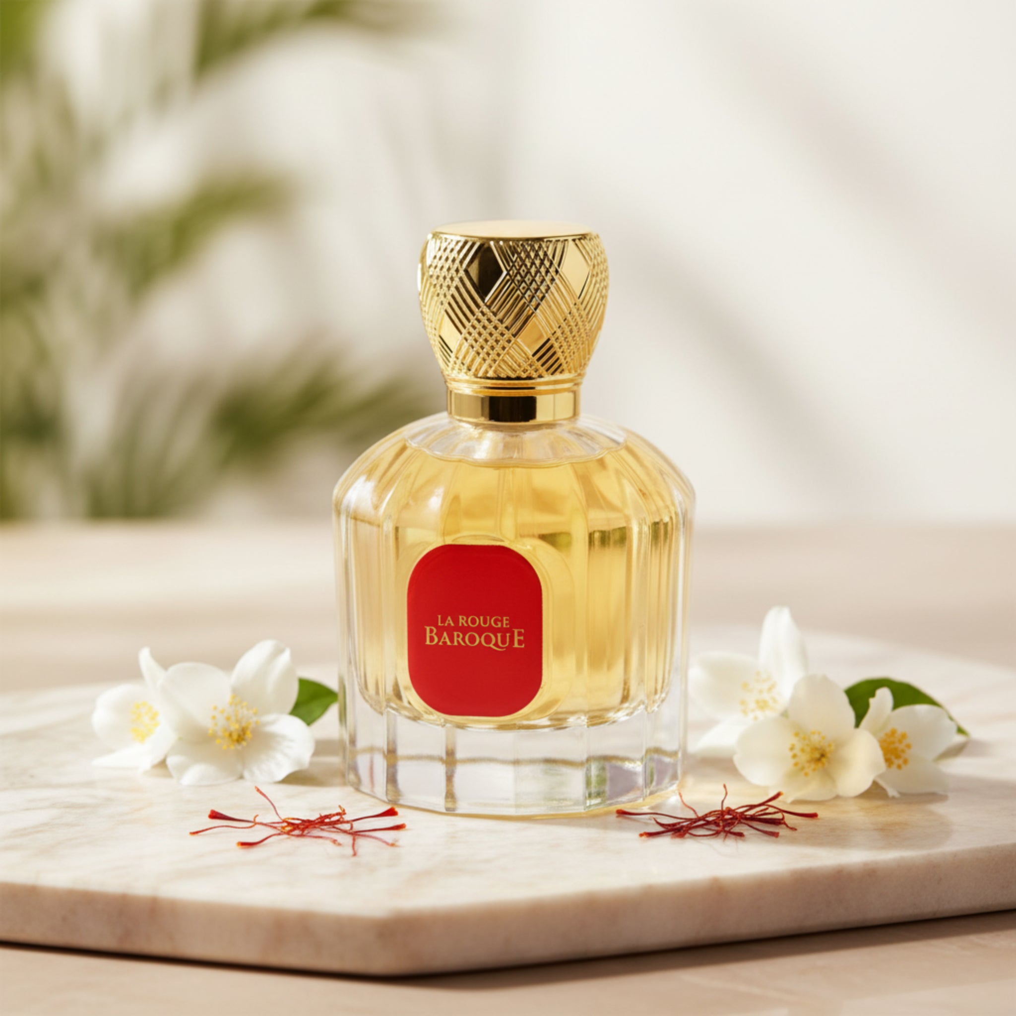 Perfume bottle with gold cap and red label on a white background
