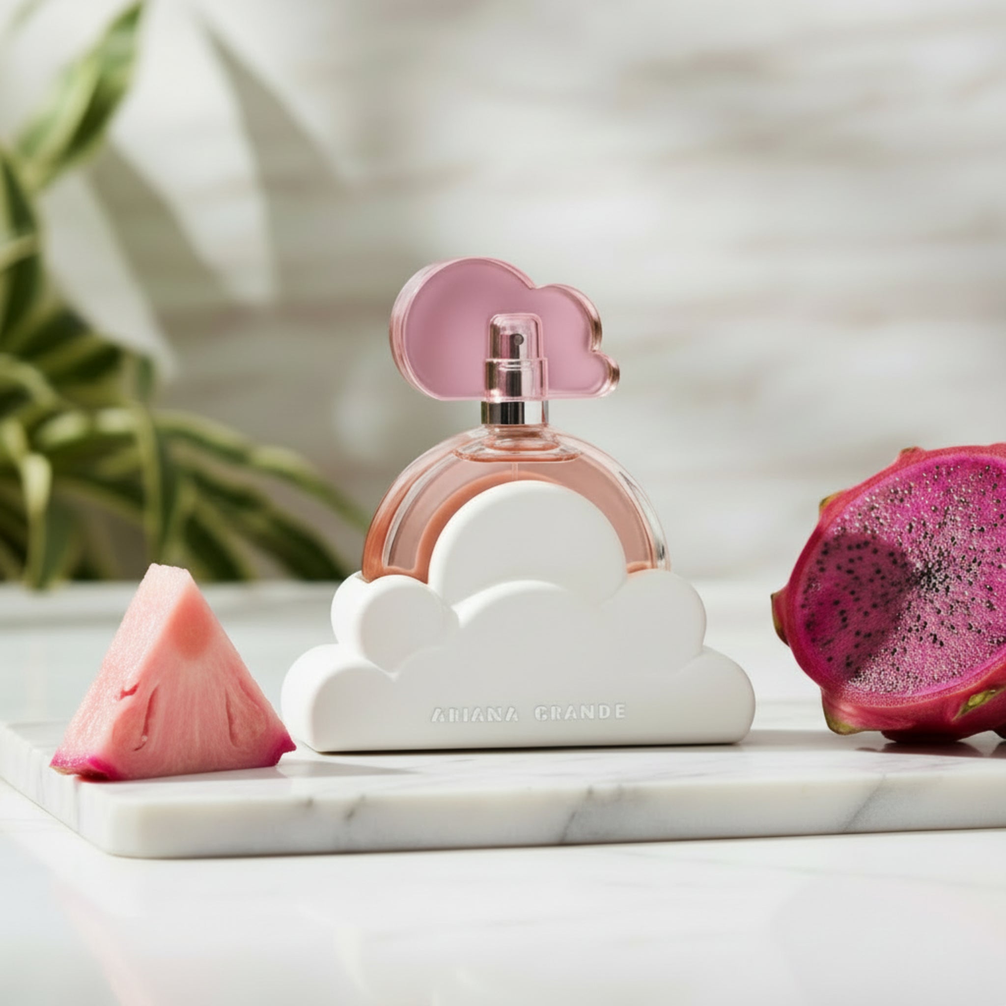 Perfume bottle with pink cap and cloud-shaped base on a white background