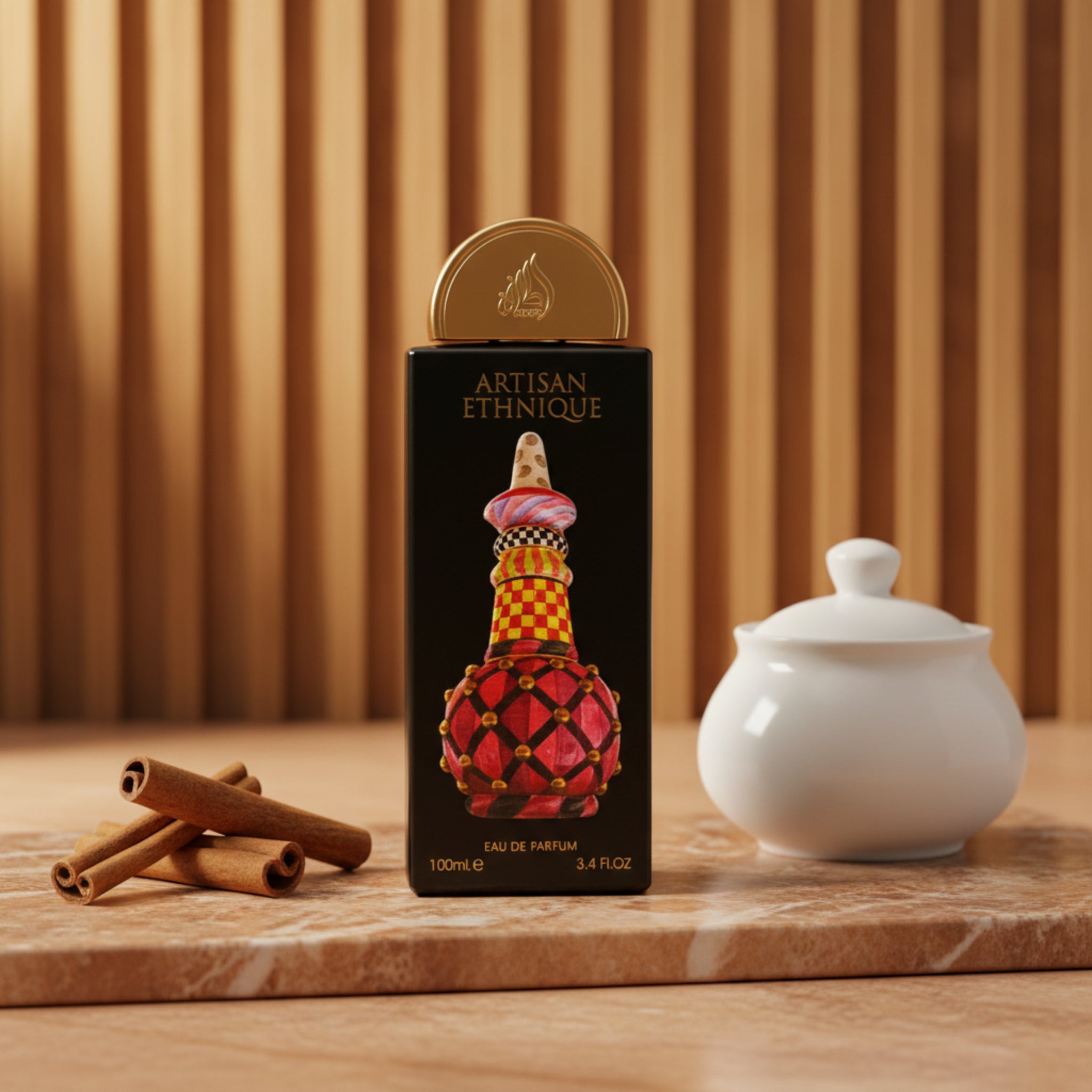 Perfume bottle with decorative design on a black box labeled 'Artisan Ethnie'.