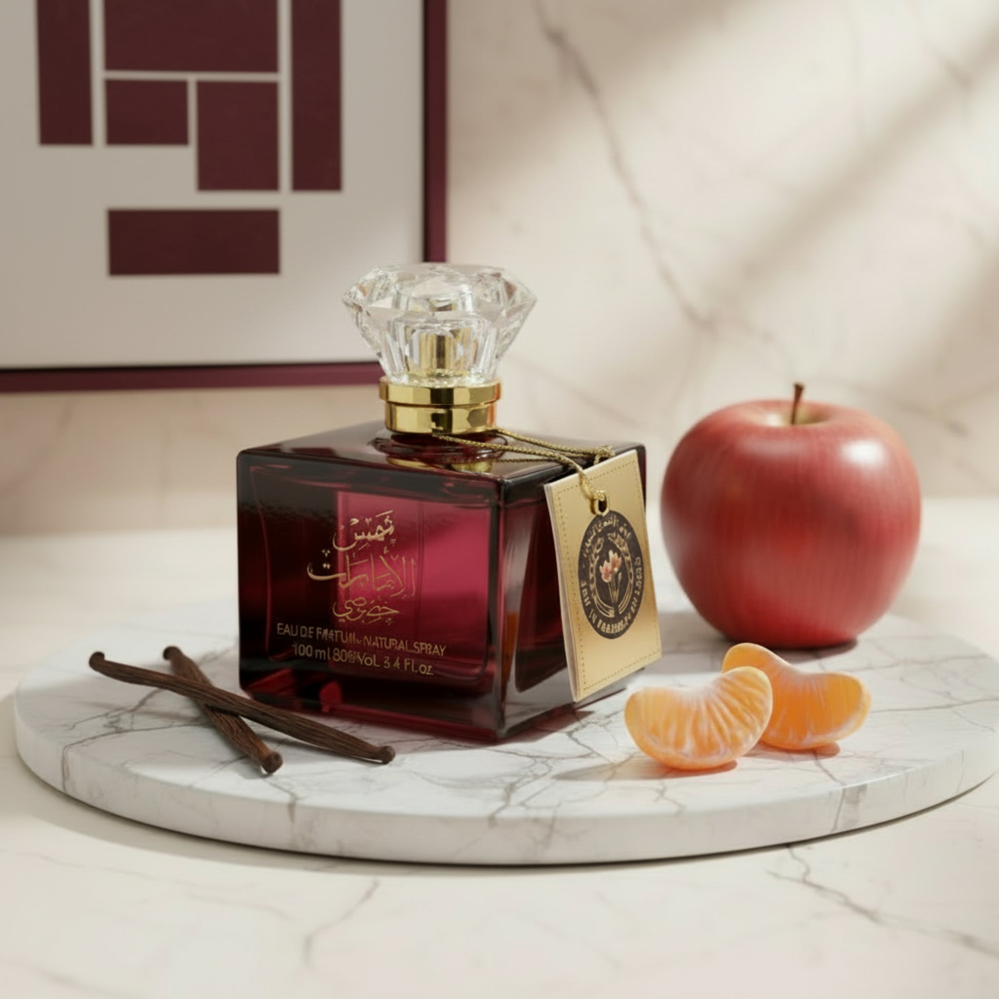 Perfume bottle with red label and gold accents on a white background