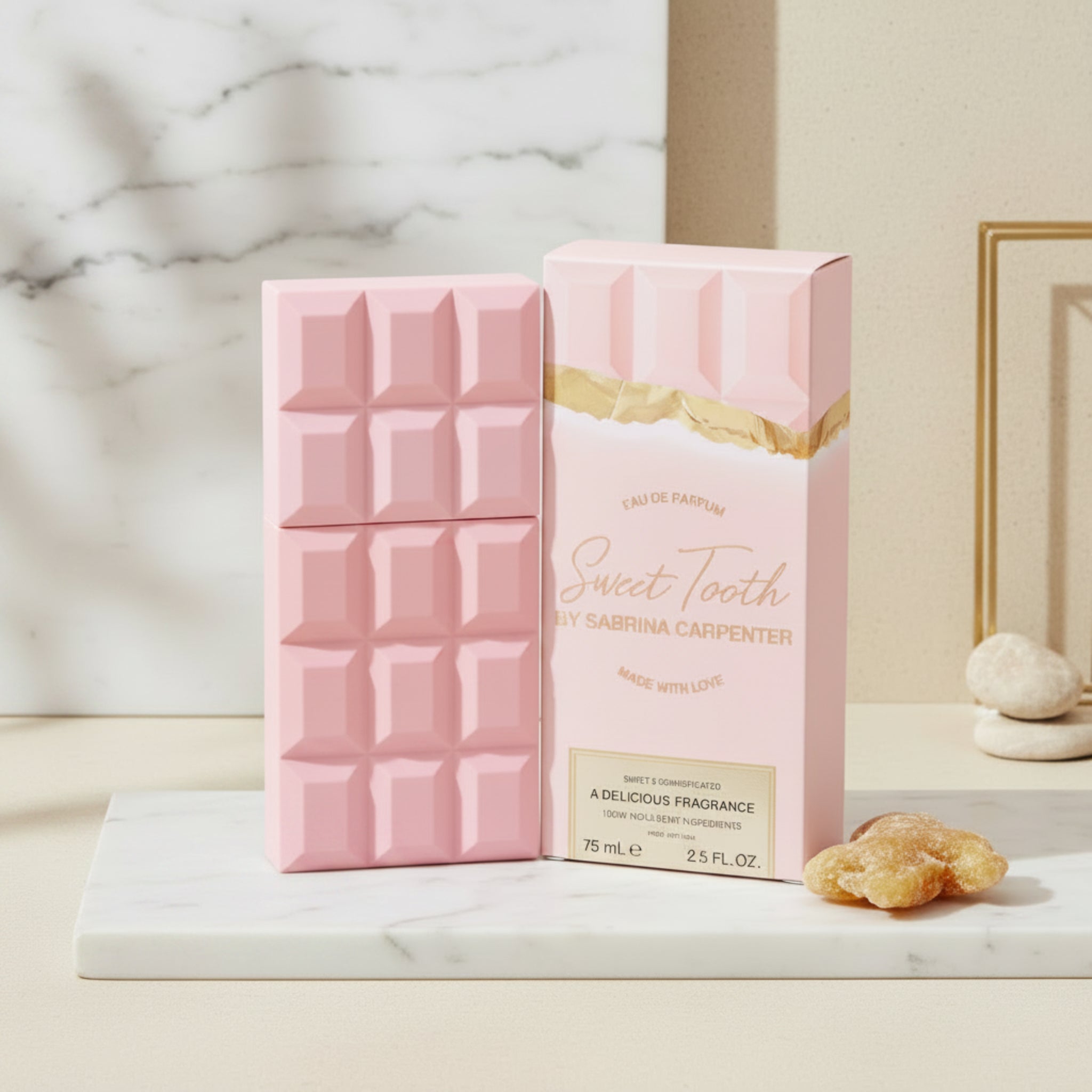 Pink perfume bottle and packaging with 'Sweet Tooth' branding on a white background