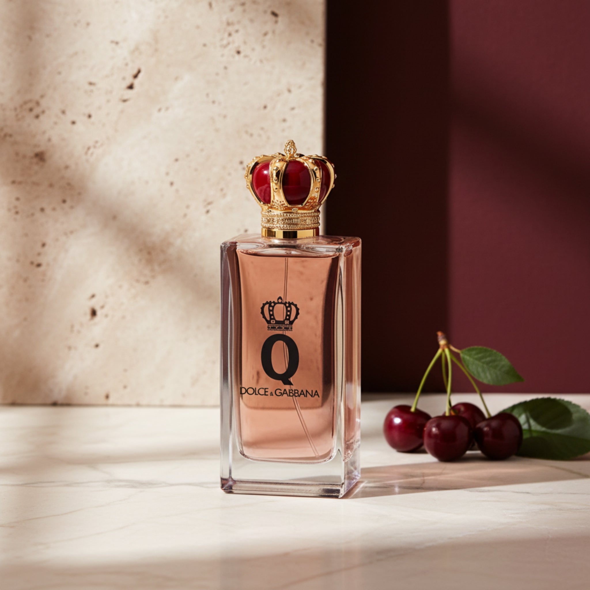 Dolce & Gabbana perfume bottle with decorative crown on a white background