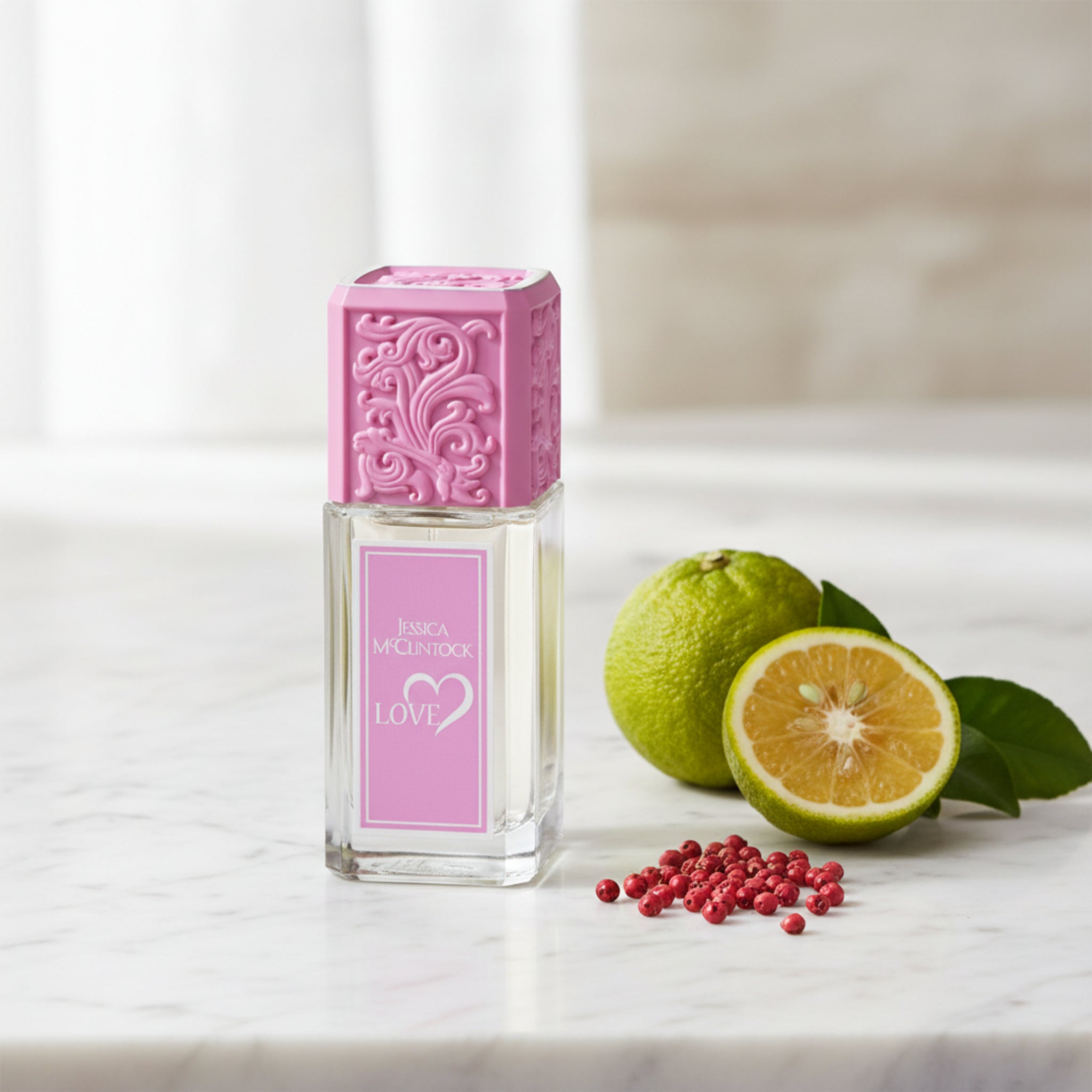 Perfume bottle with pink cap and label on a white background