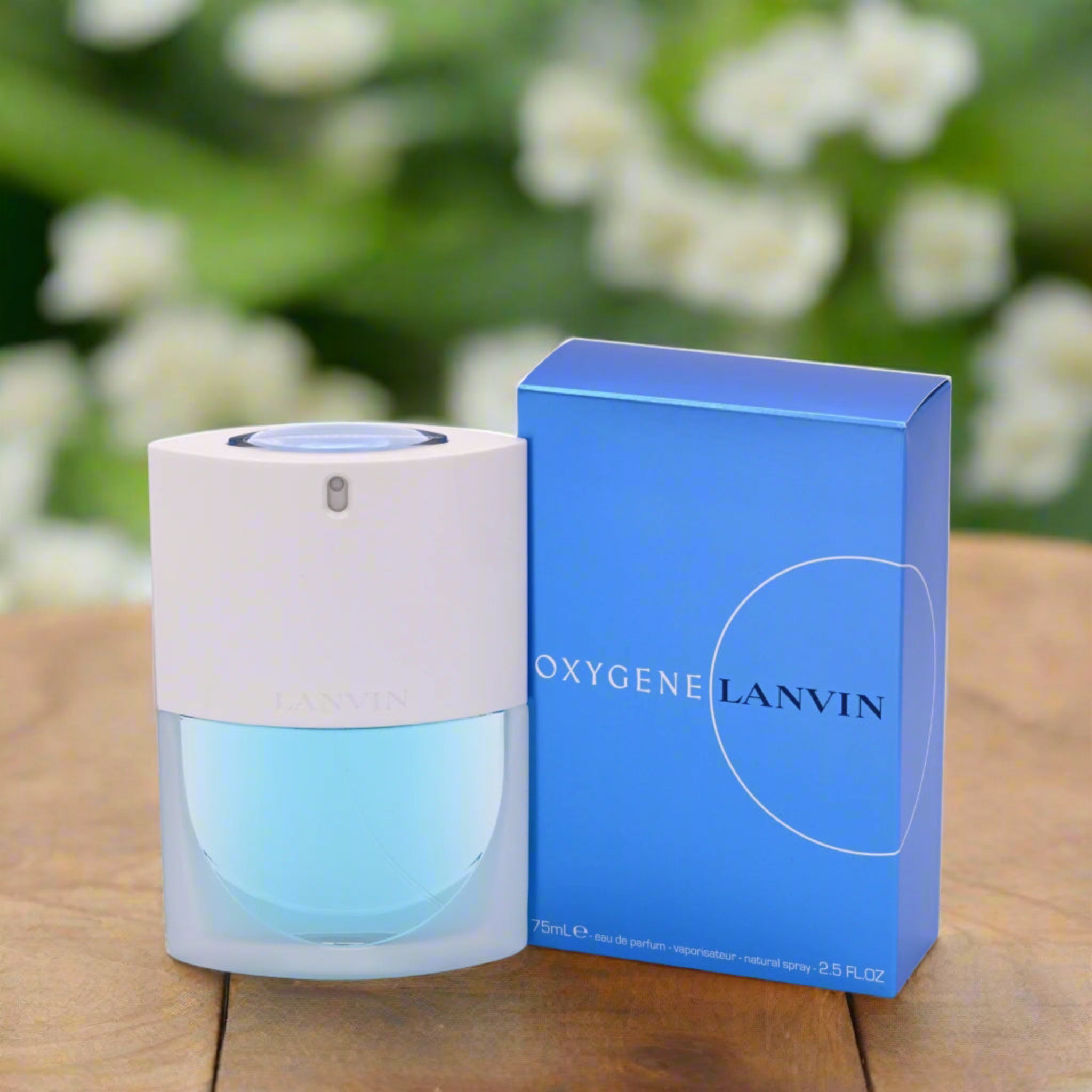 Lanvin Oxygene perfume bottle and packaging on a wooden surface with a blurred floral background