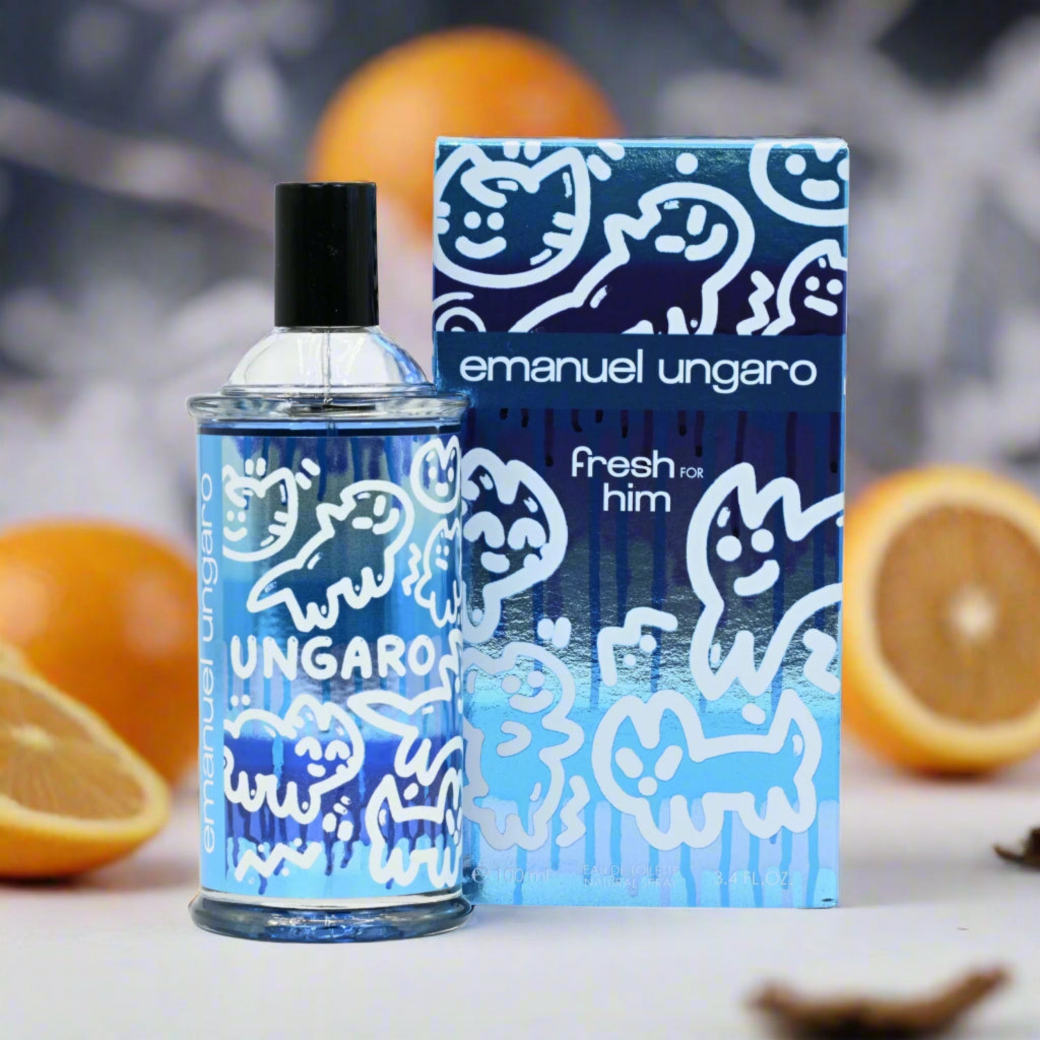 Emanuel Ungaro perfume bottle and packaging with oranges in the background