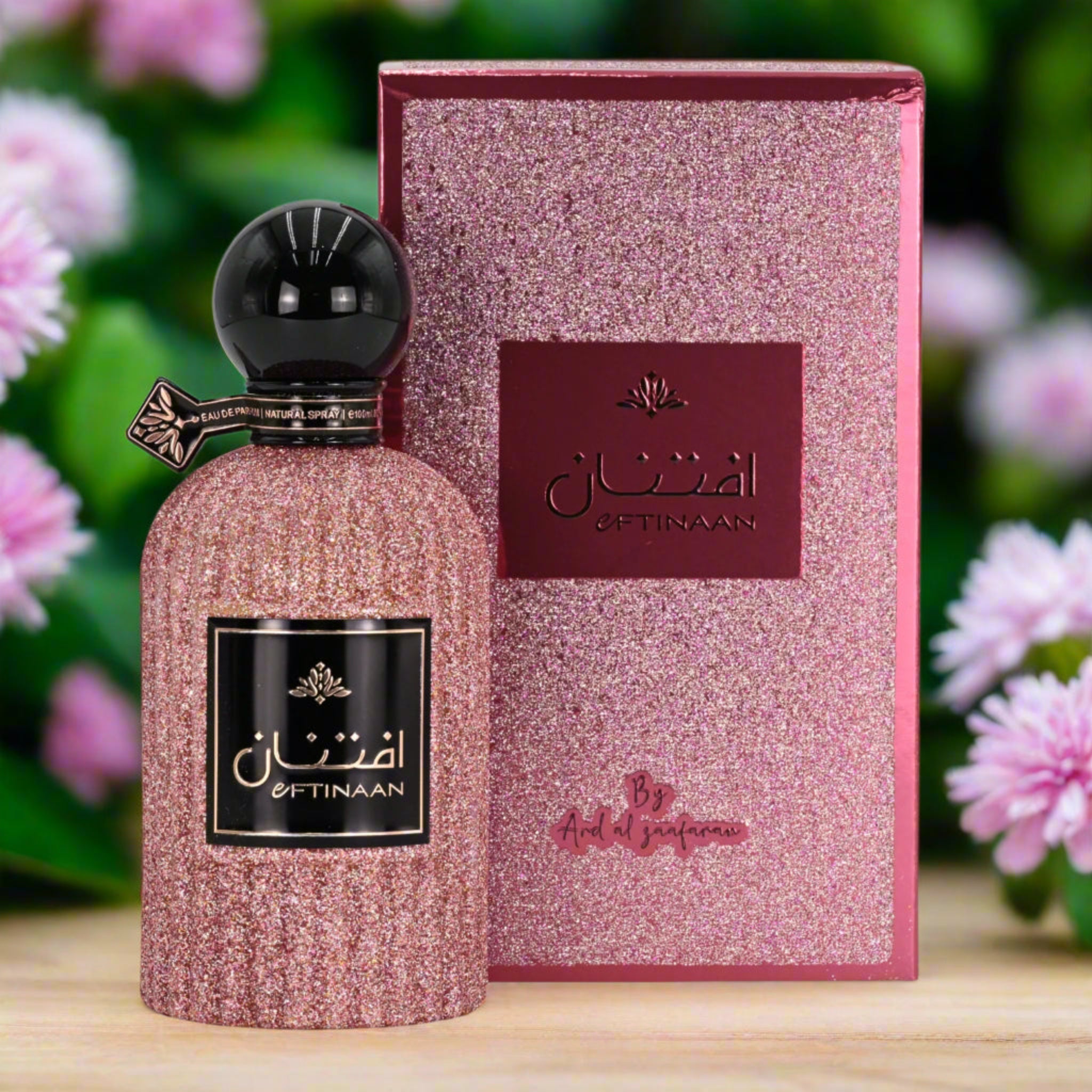 Pink glittery perfume bottle and packaging with 'Offinaan' branding against a floral background