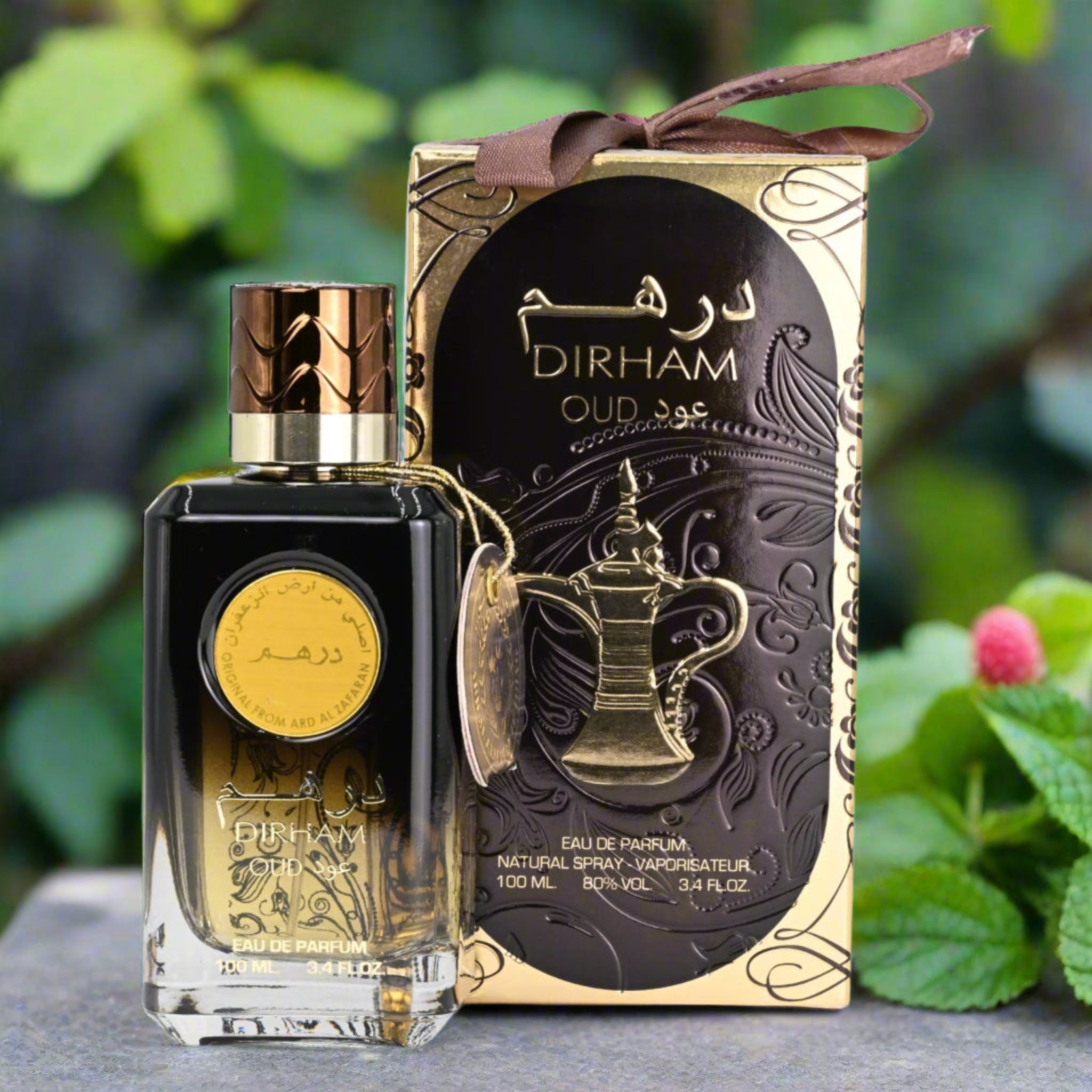 Dirham Oud perfume bottle and packaging with a decorative ribbon against a natural background.
