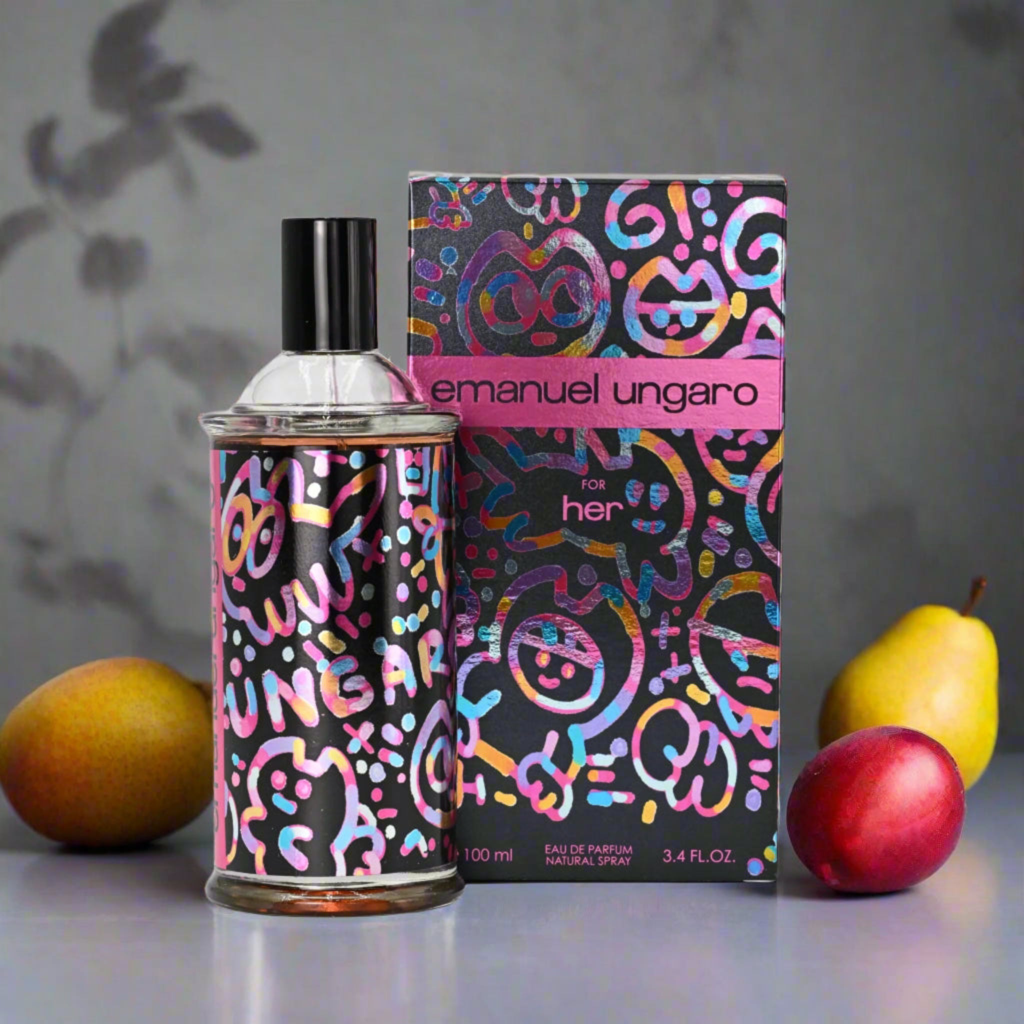 Emanuel Ungaro perfume bottle and packaging with fruits on a gray background