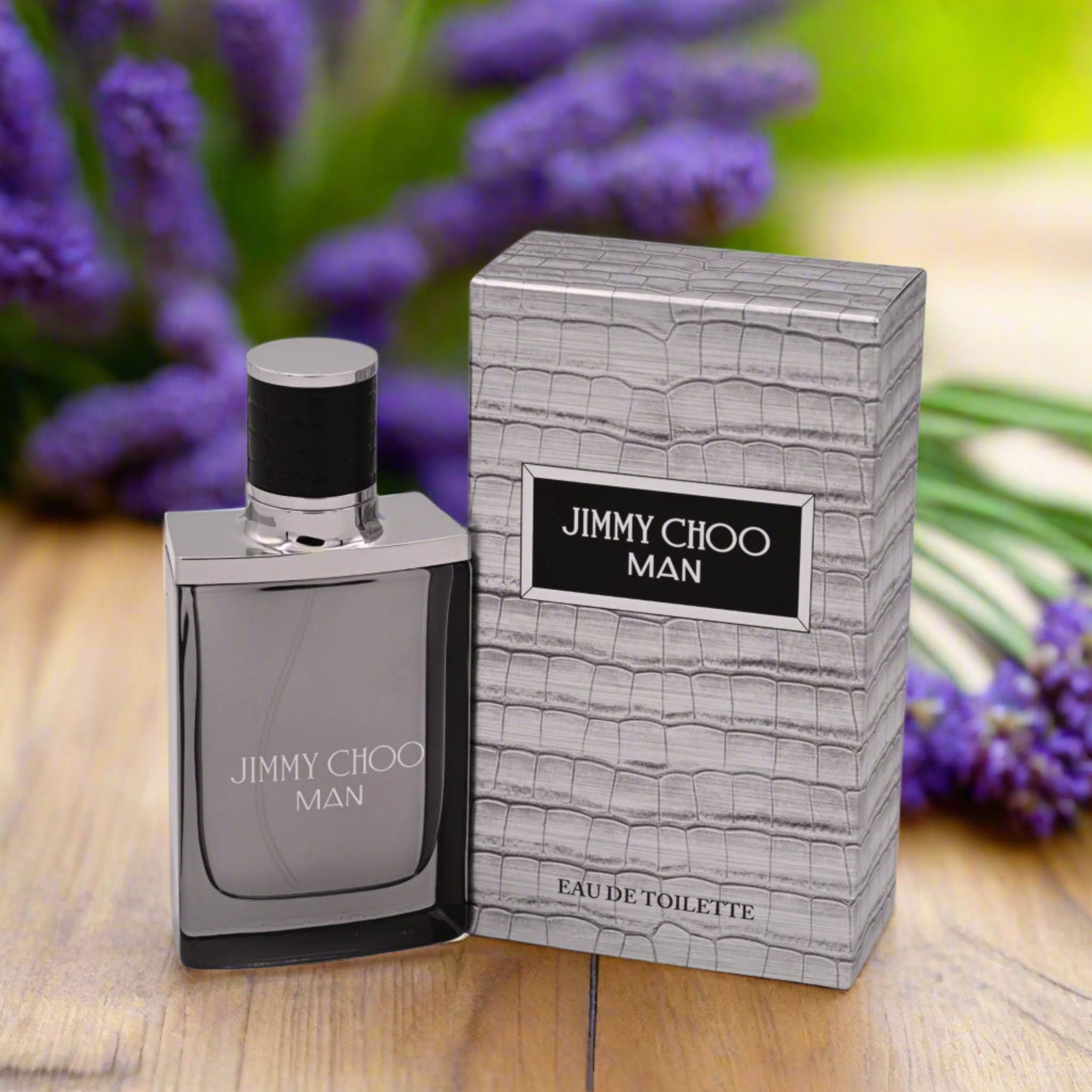 Jimmy Choo Man perfume bottle and packaging on a wooden surface with lavender flowers in the background