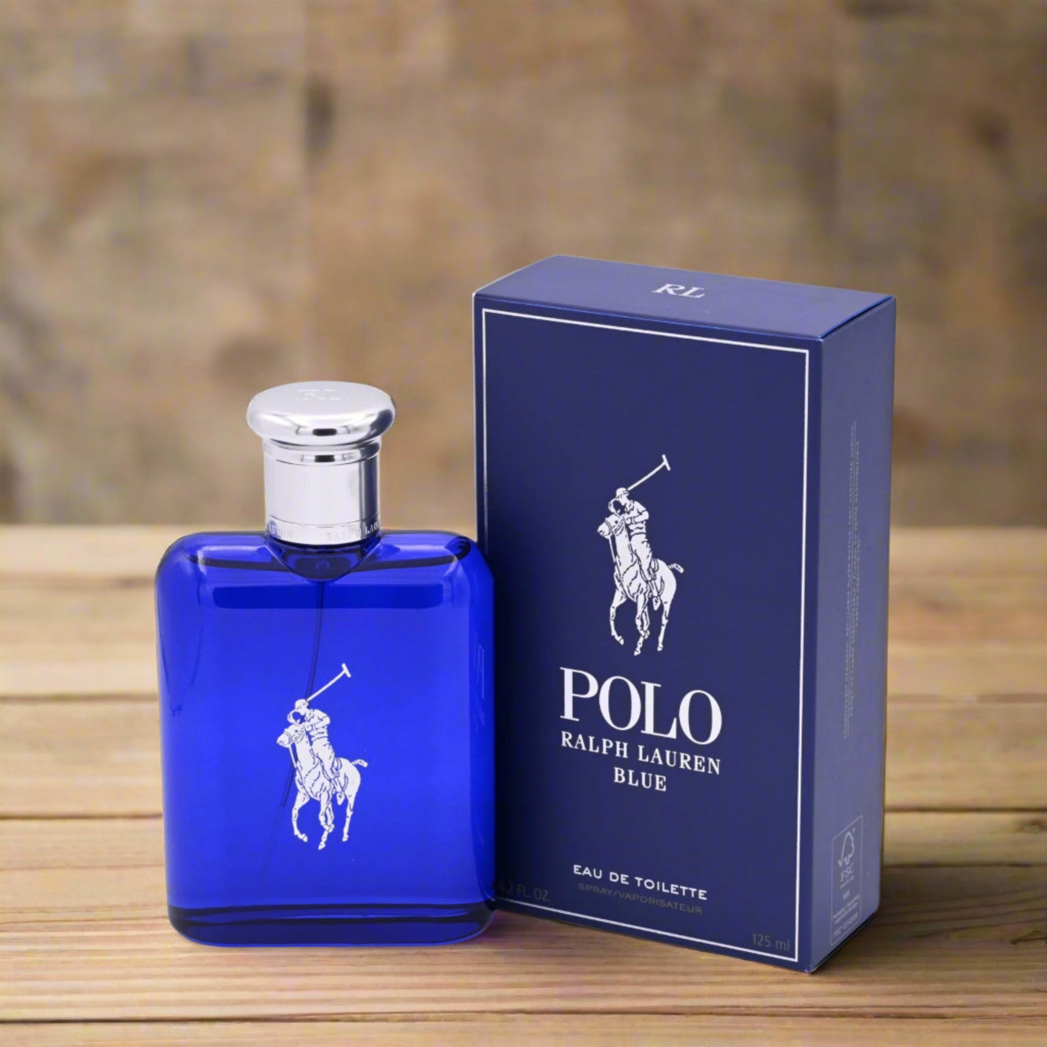 Blue Polo Ralph Lauren perfume bottle and packaging on a wooden surface with blurred background