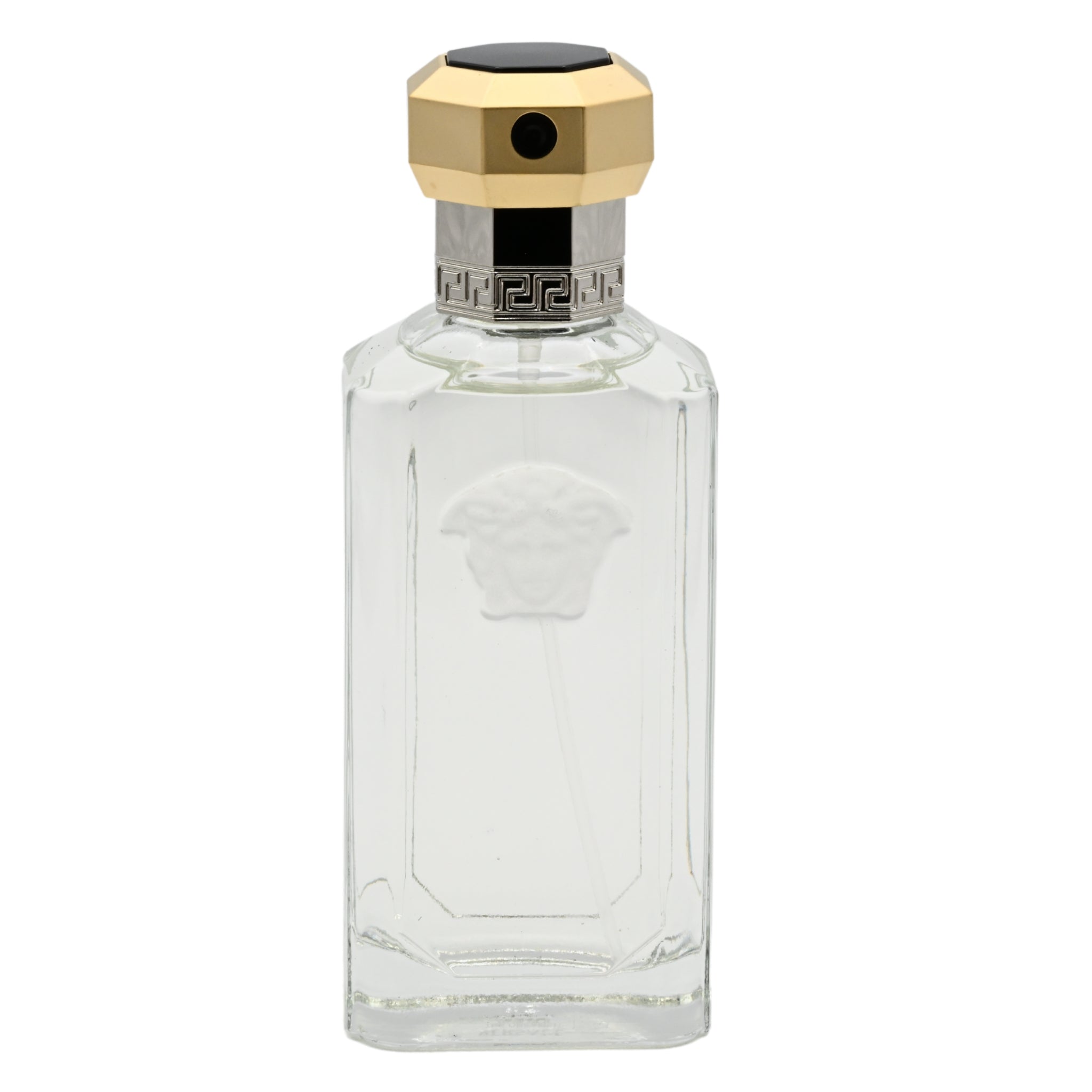Clear perfume bottle with gold cap on a white background