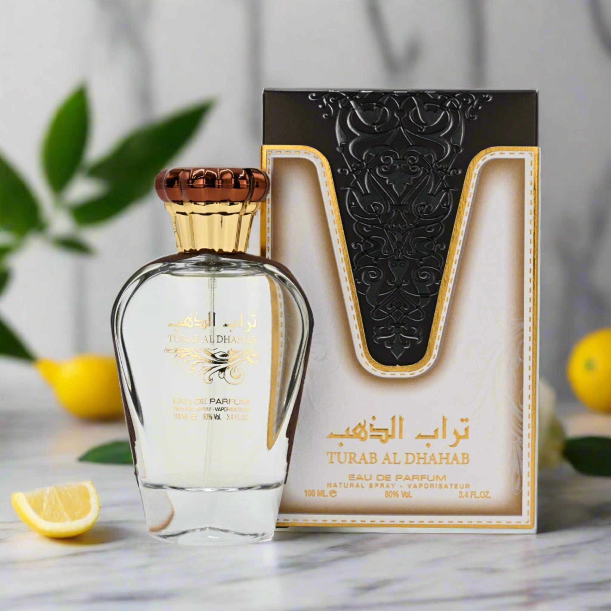 Perfume bottle and packaging with decorative elements on a marble surface.