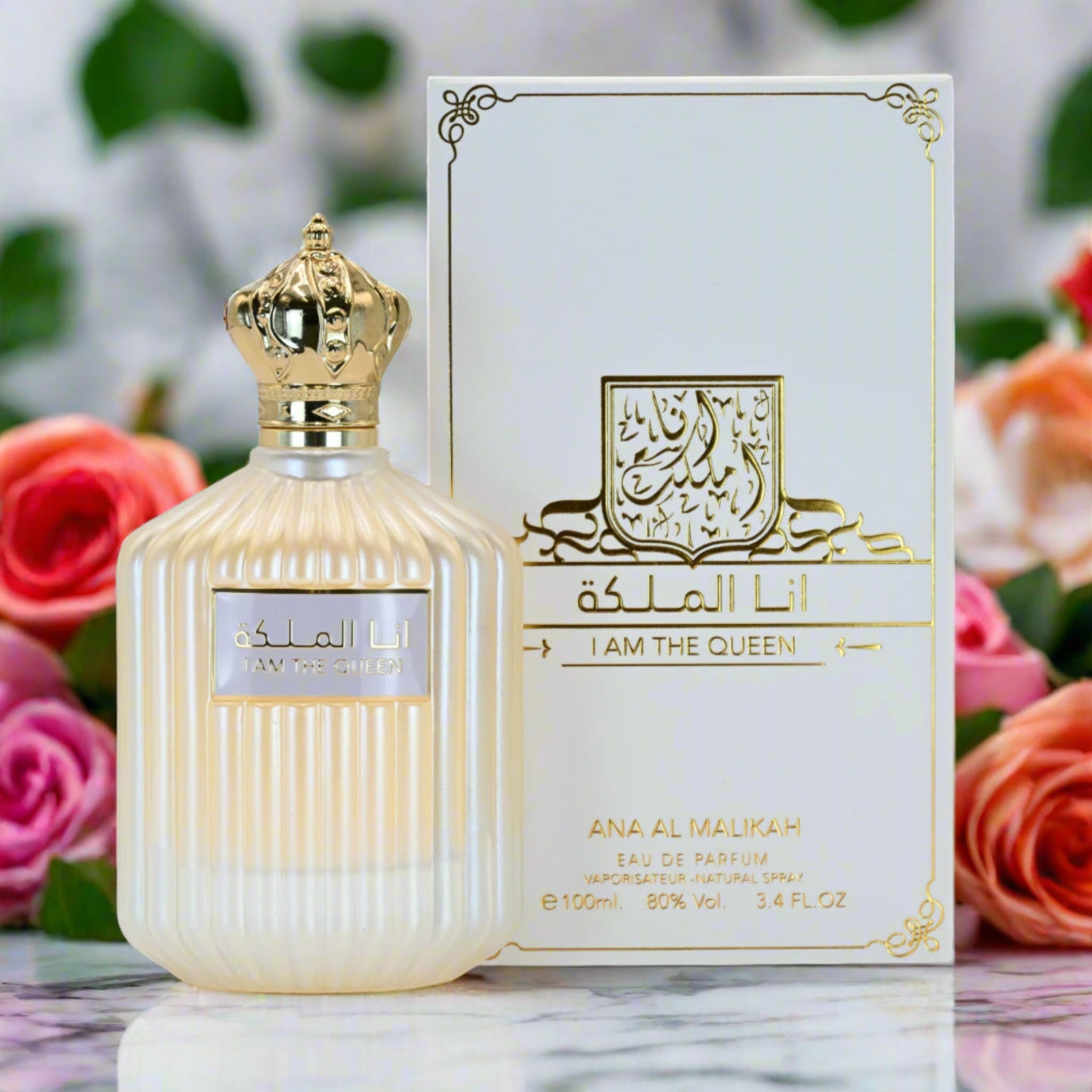 Perfume bottle and packaging of 'Ana Al Malikah I Am The Queen' with flowers in the background